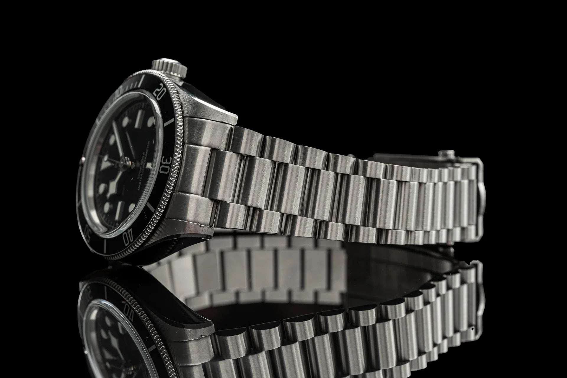 Stainless steel bracelet for Tudor Monochrome watch with solid metal links and polished finish on black background