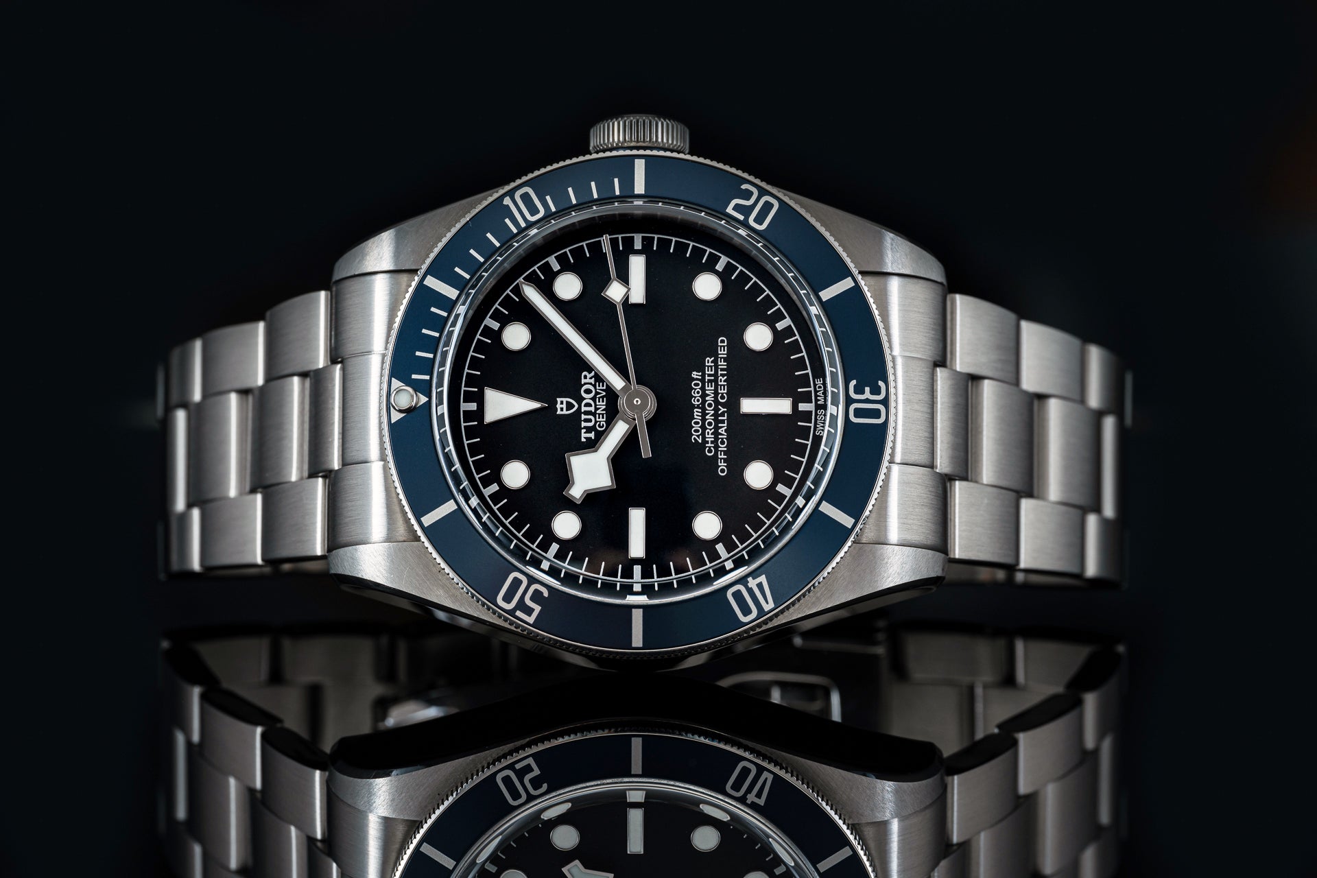 Stainless steel dive watch with blue bezel, black dial, white markers and hands, officially certified chronometer, 200m water resistance