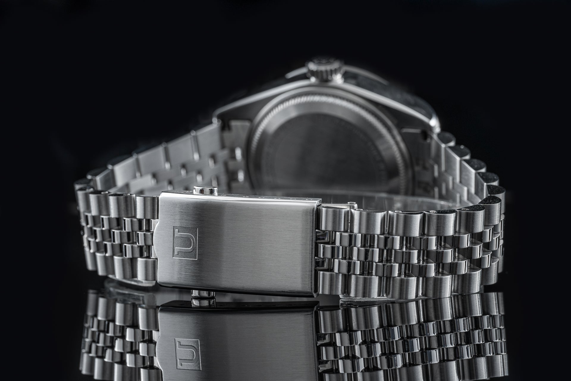 Stainless steel executive bracelet with polished clasp for Tudor Black Bay Pro watch, featuring three-link design on black background