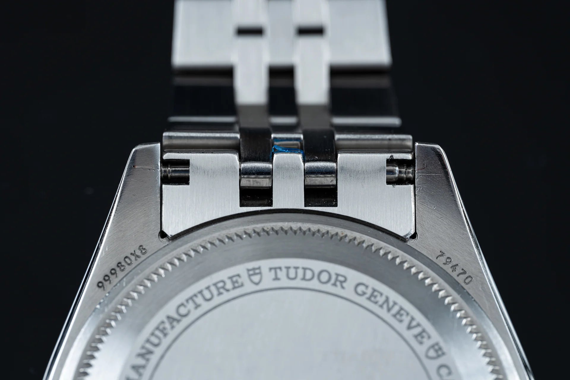 Tudor Black Bay 58 GMT watch with stainless steel bracelet and black rubber strap detail against dark background