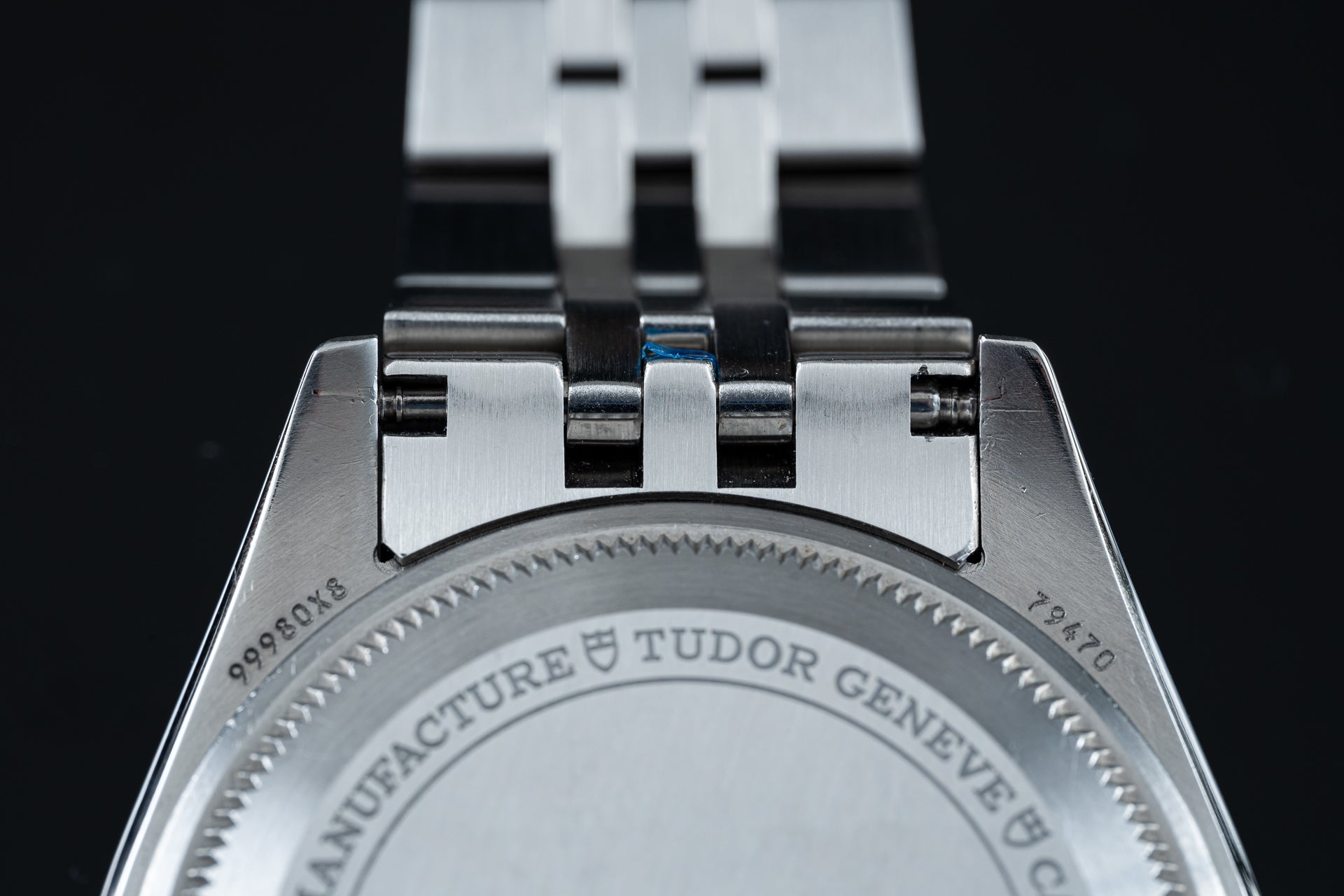 Tudor Black Bay Pro stainless steel bracelet with white rubber strap connector, closeup of clasp and links