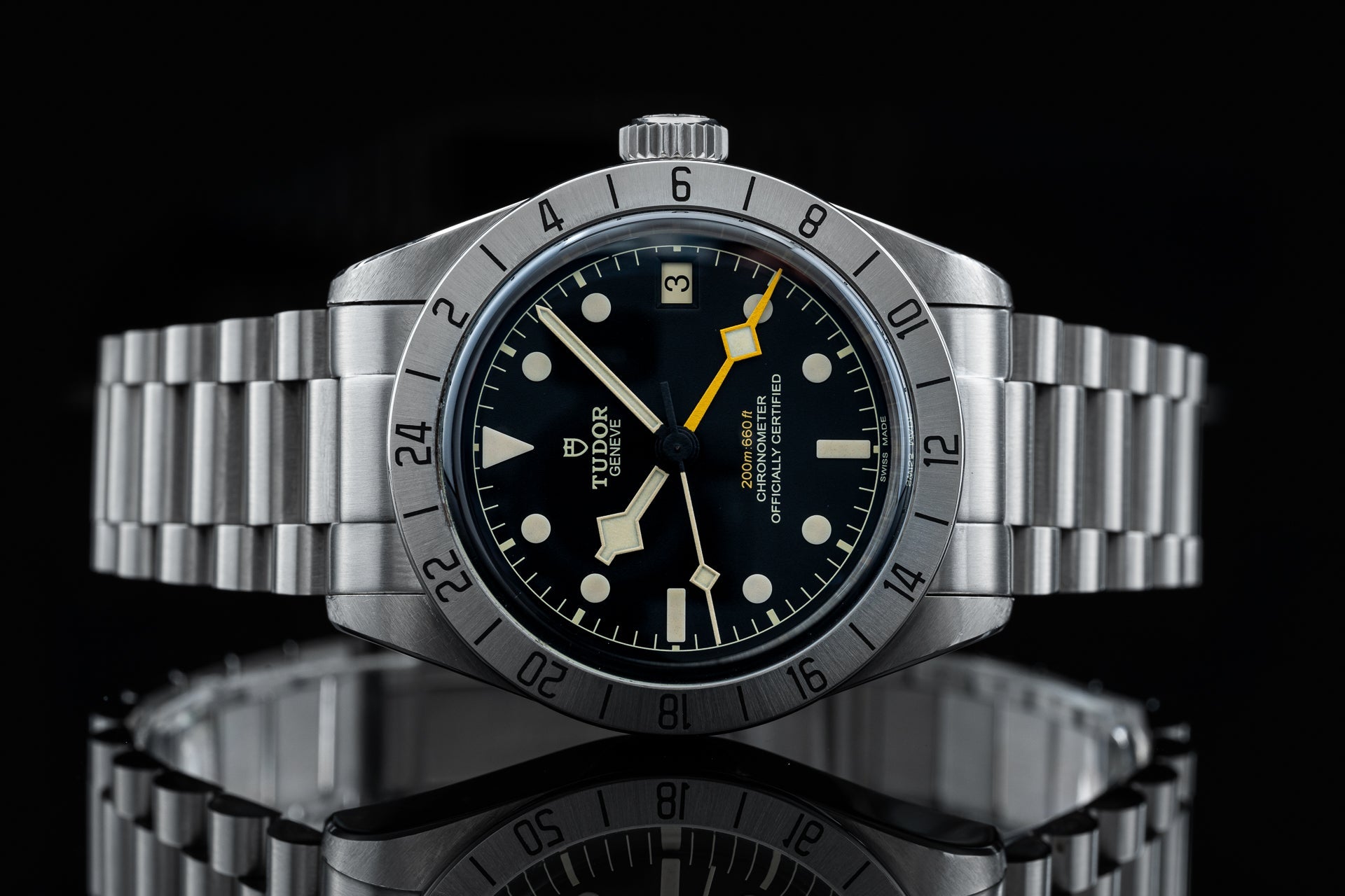 Tudor Black Bay Pro dive watch with stainless steel bracelet, black dial, luminous hands, and rotating bezel on black background