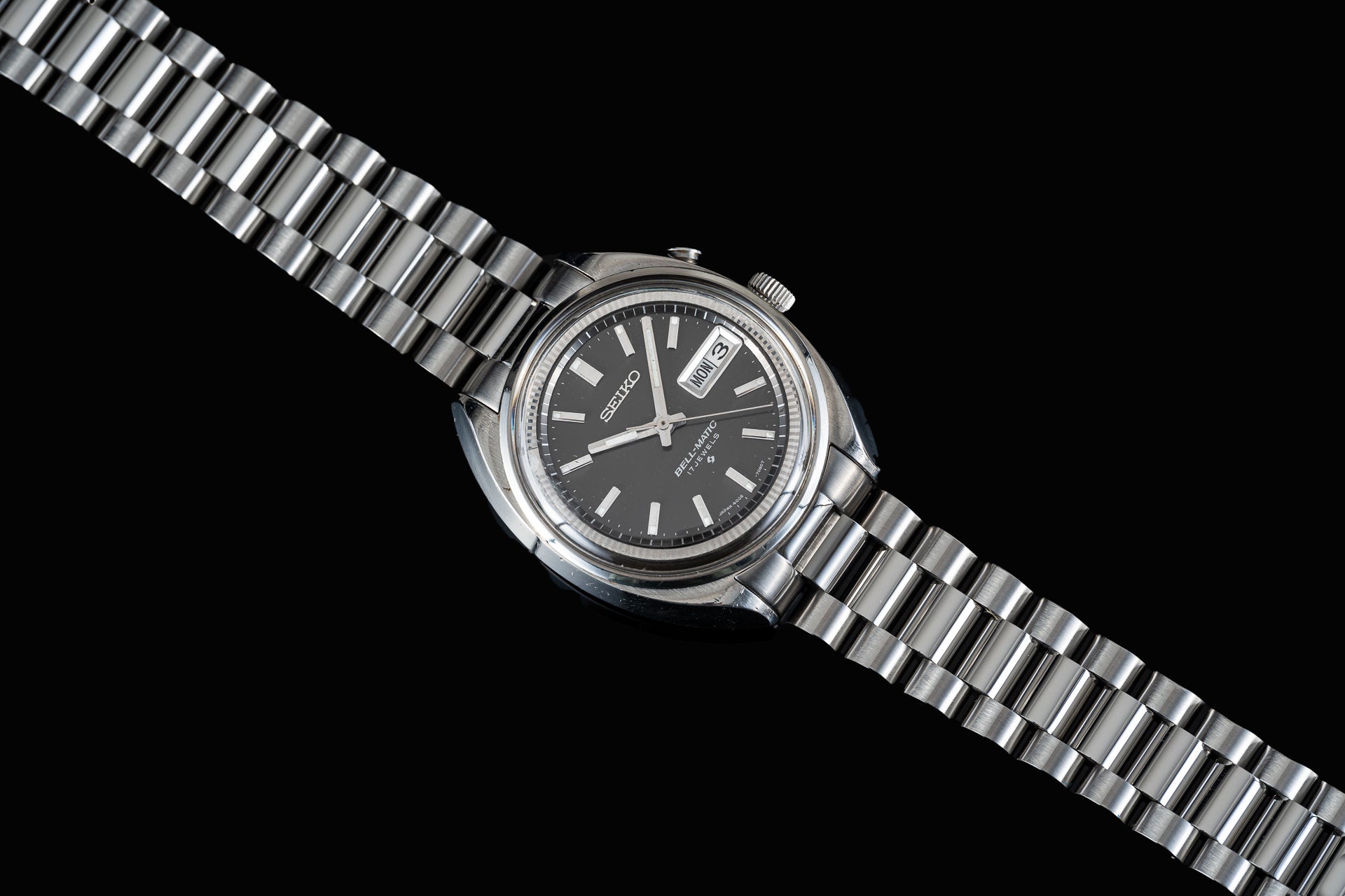 Seiko Bell-Matic 4006-7001 automatic watch with black dial, day-date window, stainless steel bracelet on black background