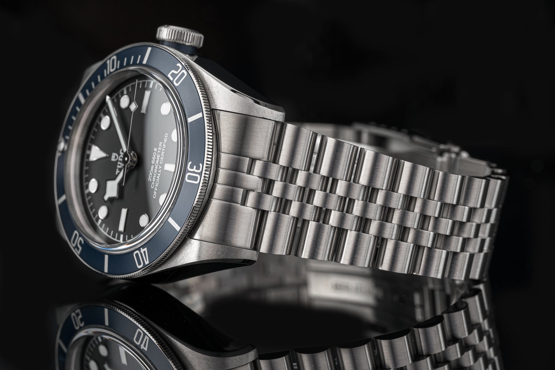 Stainless steel executive bracelet for Tudor 41mm watches with polished and brushed links on black background