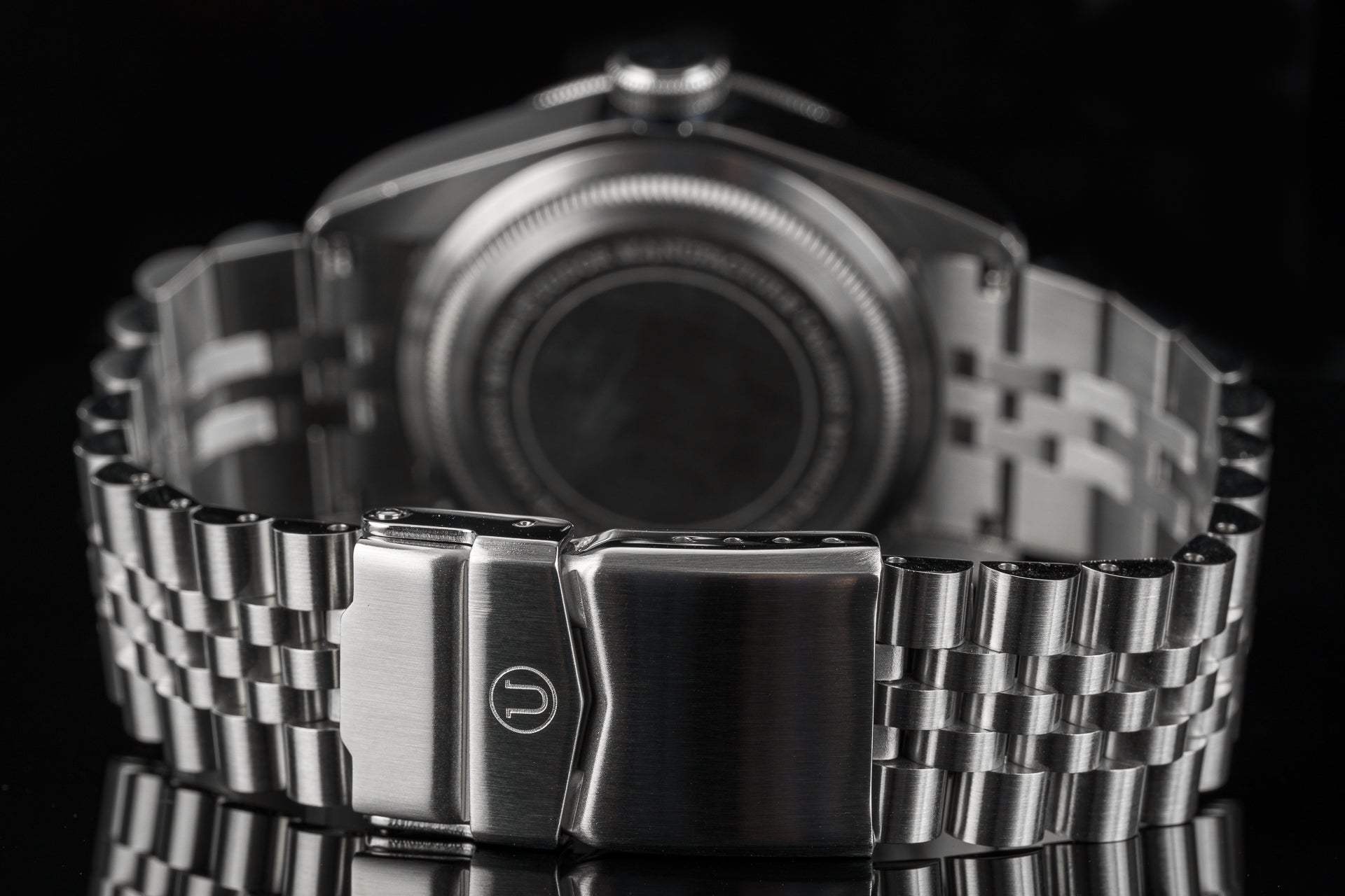 Stainless steel metal bracelet with fold-over clasp for Tudor 41mm watch models, front view against black background