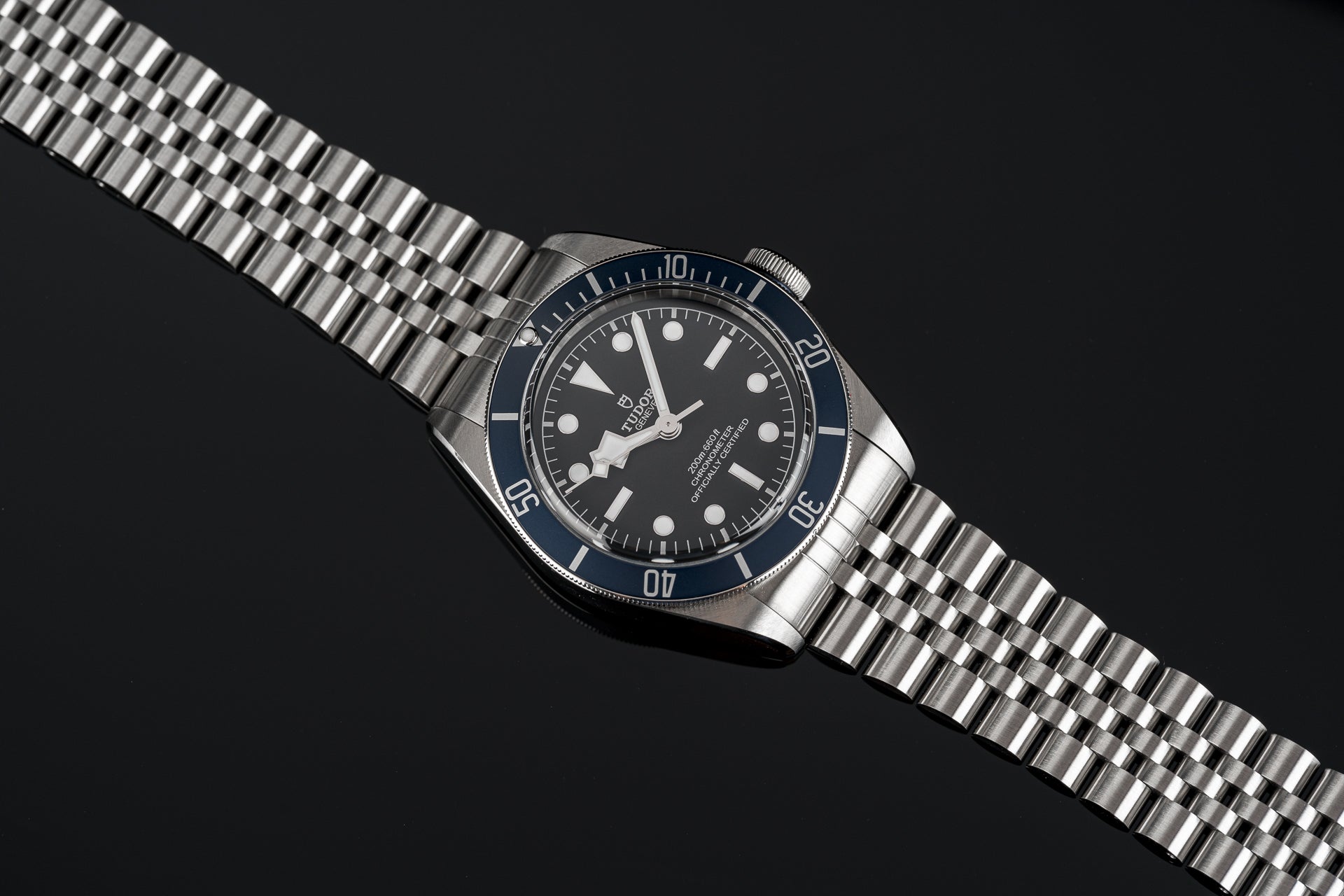 Stainless steel bracelet for Tudor 41mm watch with solid end links and polished three-link construction on black background