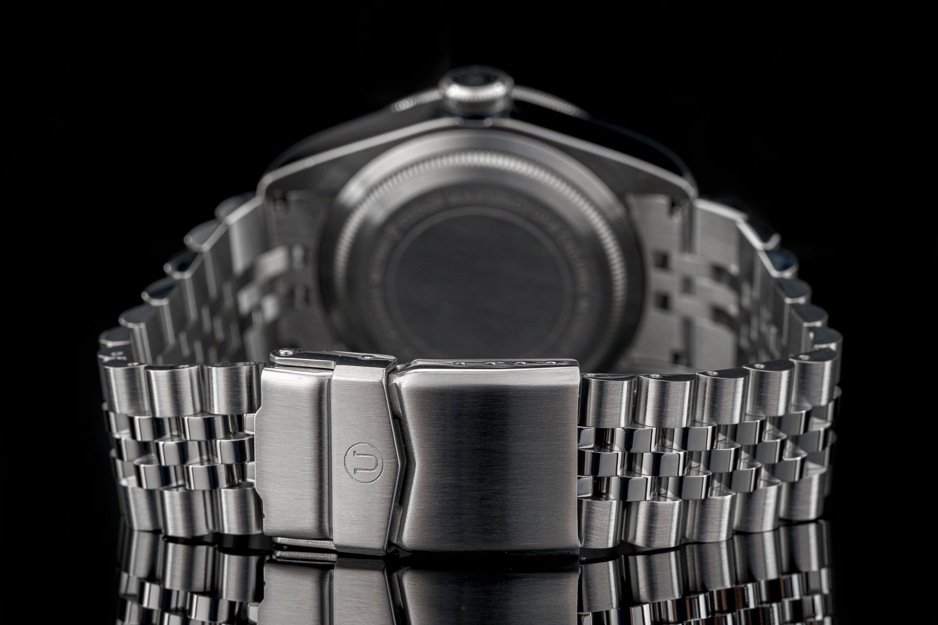 Stainless steel bracelet with fold-over clasp for Tudor 41mm watch models, back view on black background