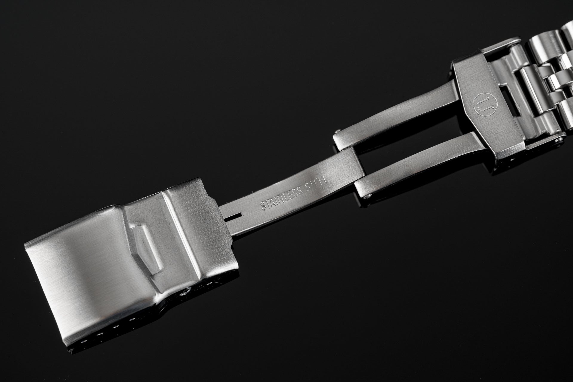 Stainless steel watch bracelet with deployant clasp for Tudor 41mm models, featuring brushed finish and solid links on black background