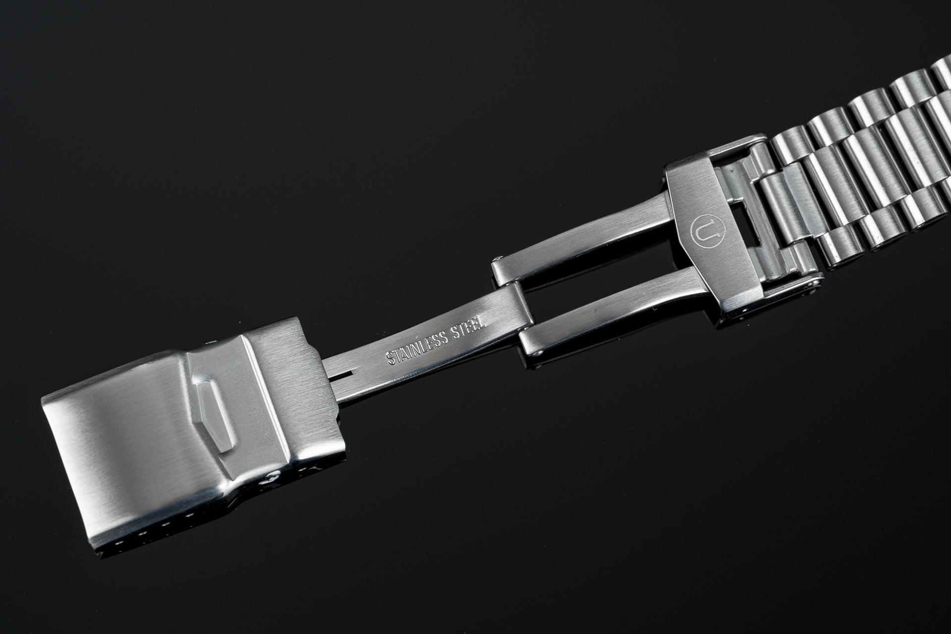 Stainless steel watch bracelet with polished center links and brushed outer links, featuring secure clasp closure for Tudor Black Bay 41mm