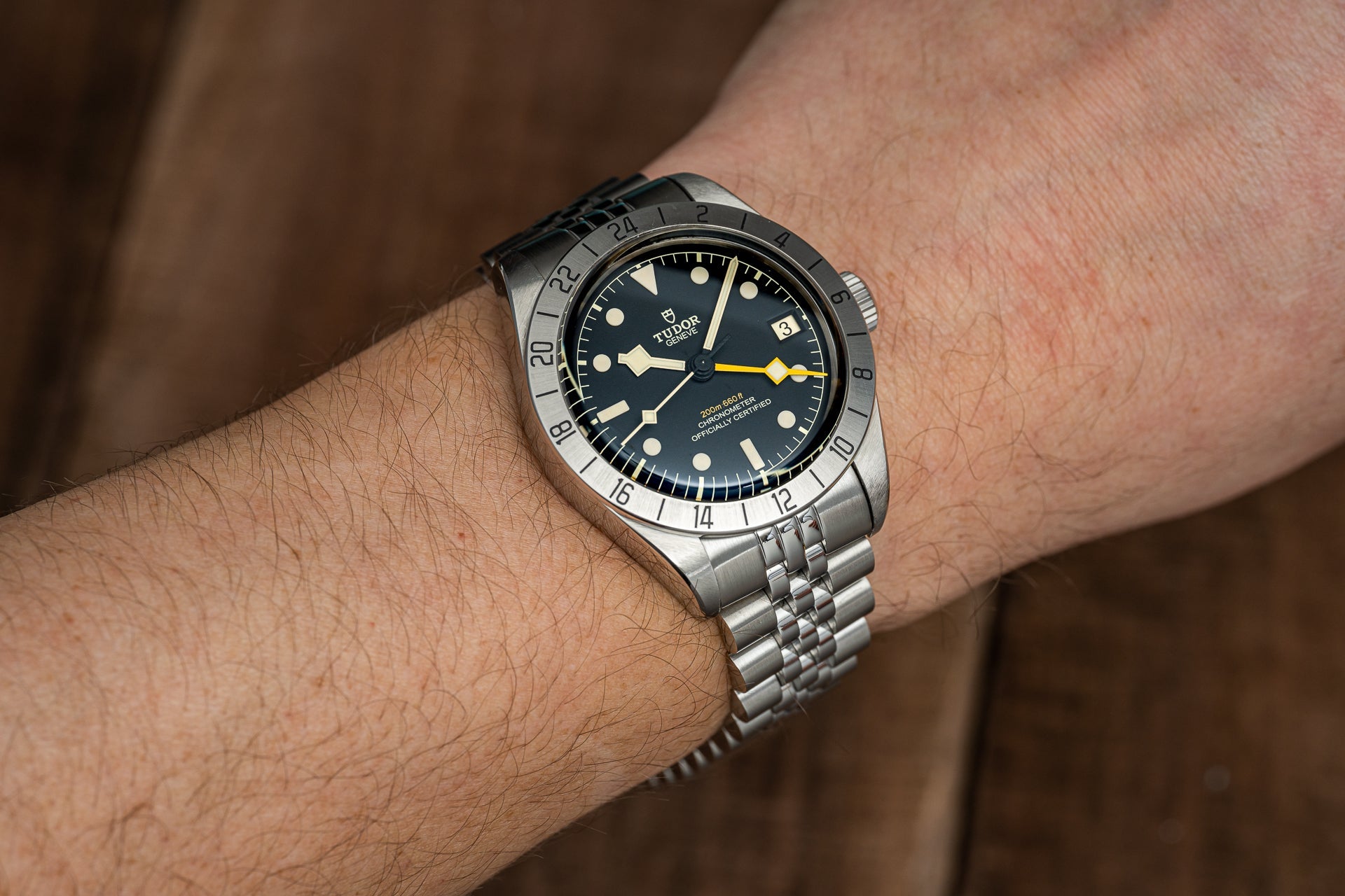 Tudor Black Bay Pro stainless steel watch with black dial, GMT bezel, and metal bracelet on wrist
