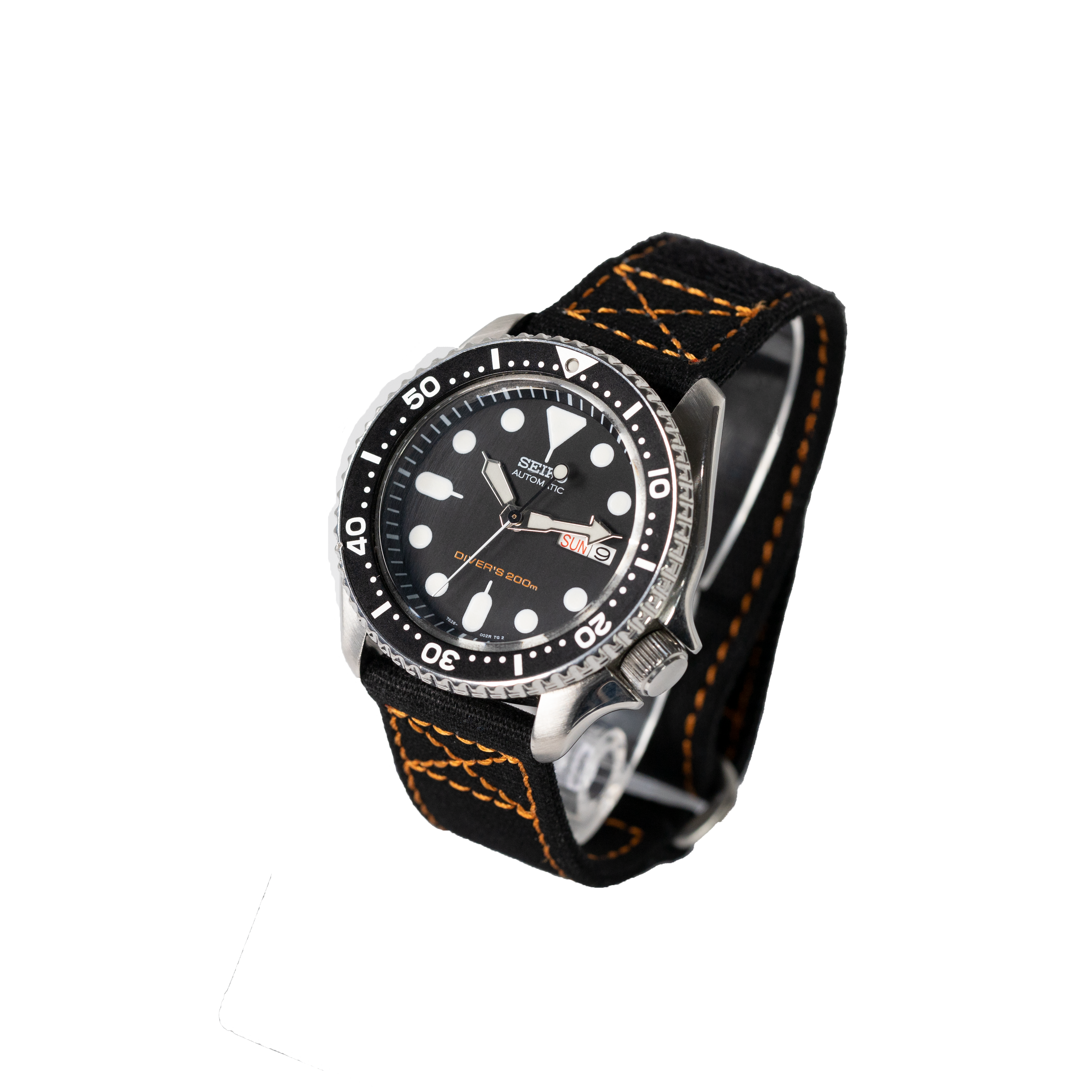 Seiko automatic dive watch with black dial, stainless steel case, rotating bezel, and black canvas strap with orange stitching