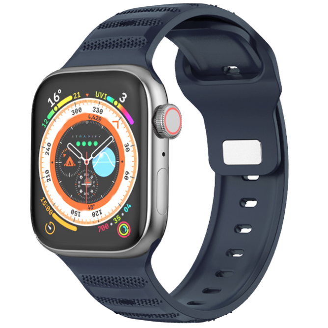 Smartwatch with ridged navy blue sports rubber band and digital compass dial display showing UV index and weather metrics