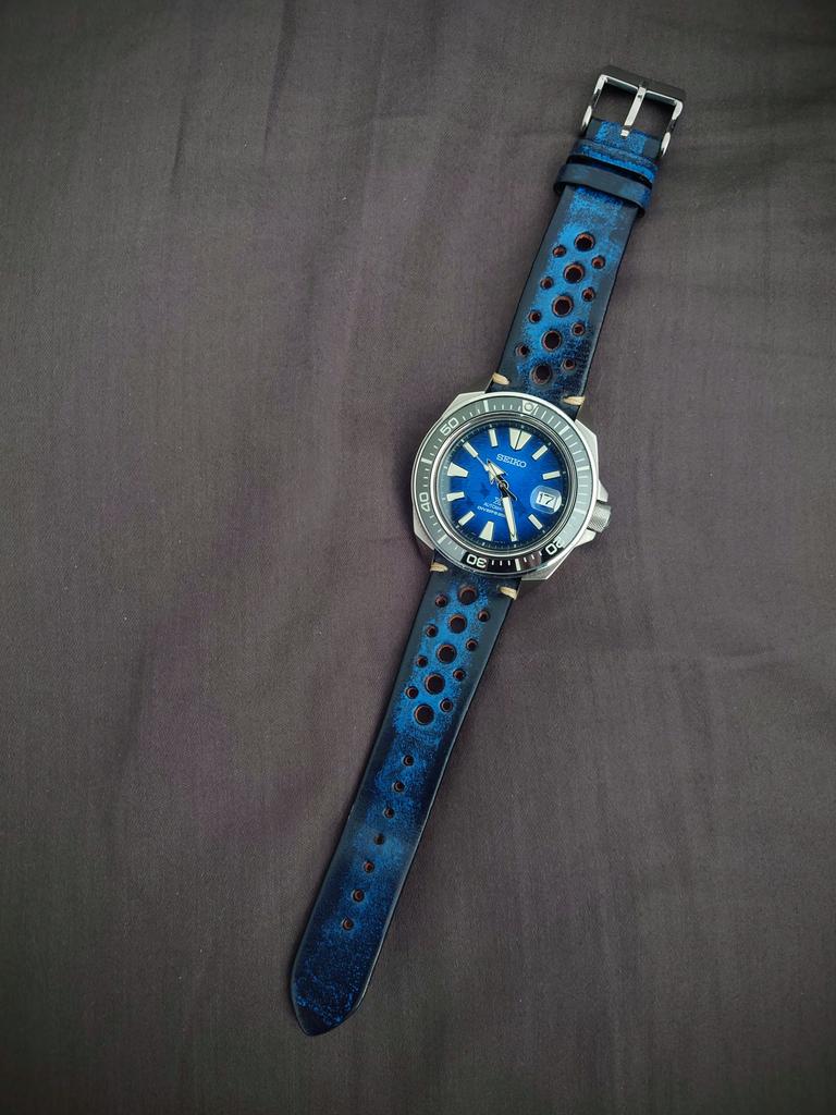 Vintage dive watch with blue dial and date window on perforated blue leather rally strap with quick release buckle