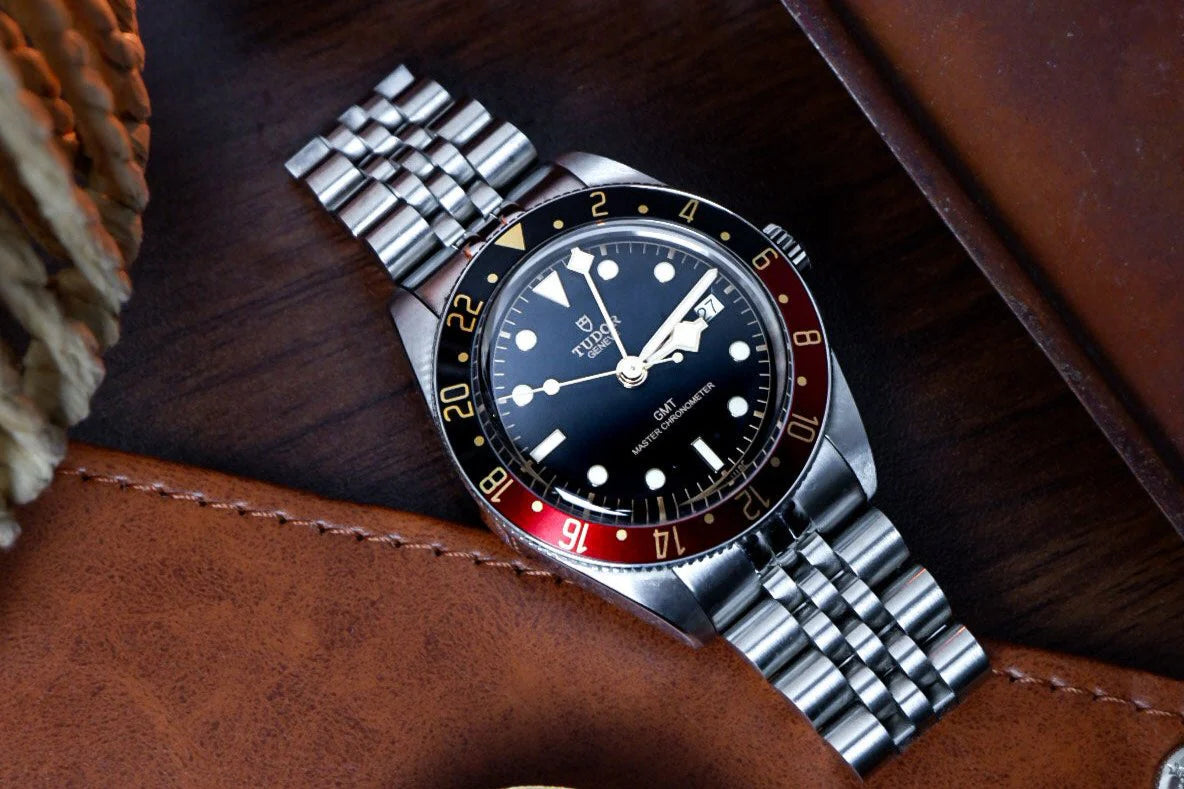 Stainless steel bracelet for Tudor Black Bay 58 GMT watch with solid end links and polished center links on leather background