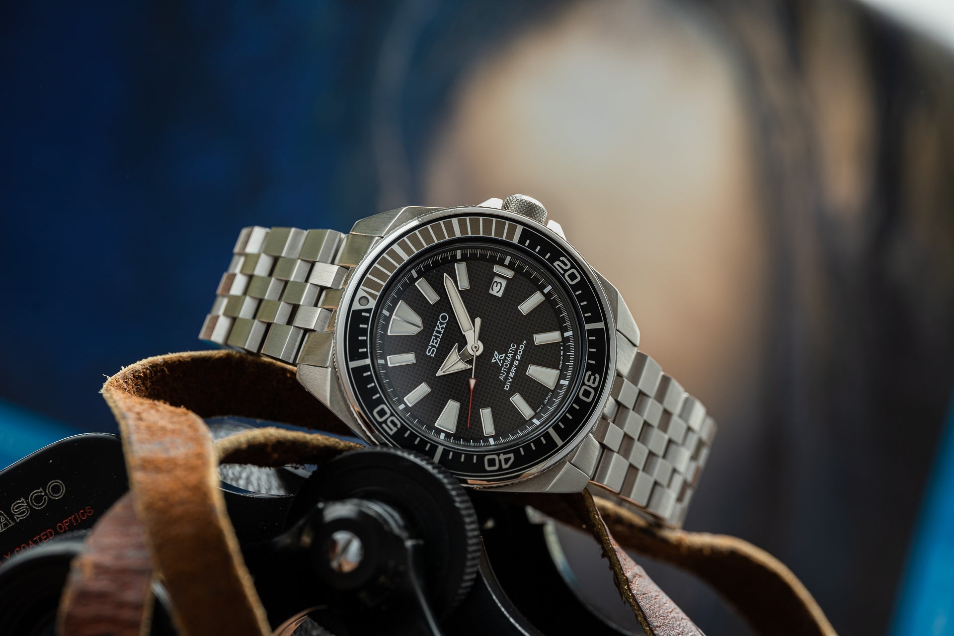 Seiko Samurai stainless steel diver watch with black dial, date window, and matching bracelet on leather strap