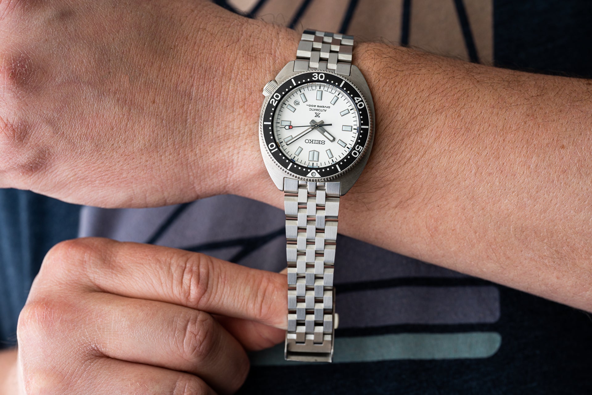 Seiko SPB317 Slim Turtle dive watch with stainless steel bracelet and white dial on wrist