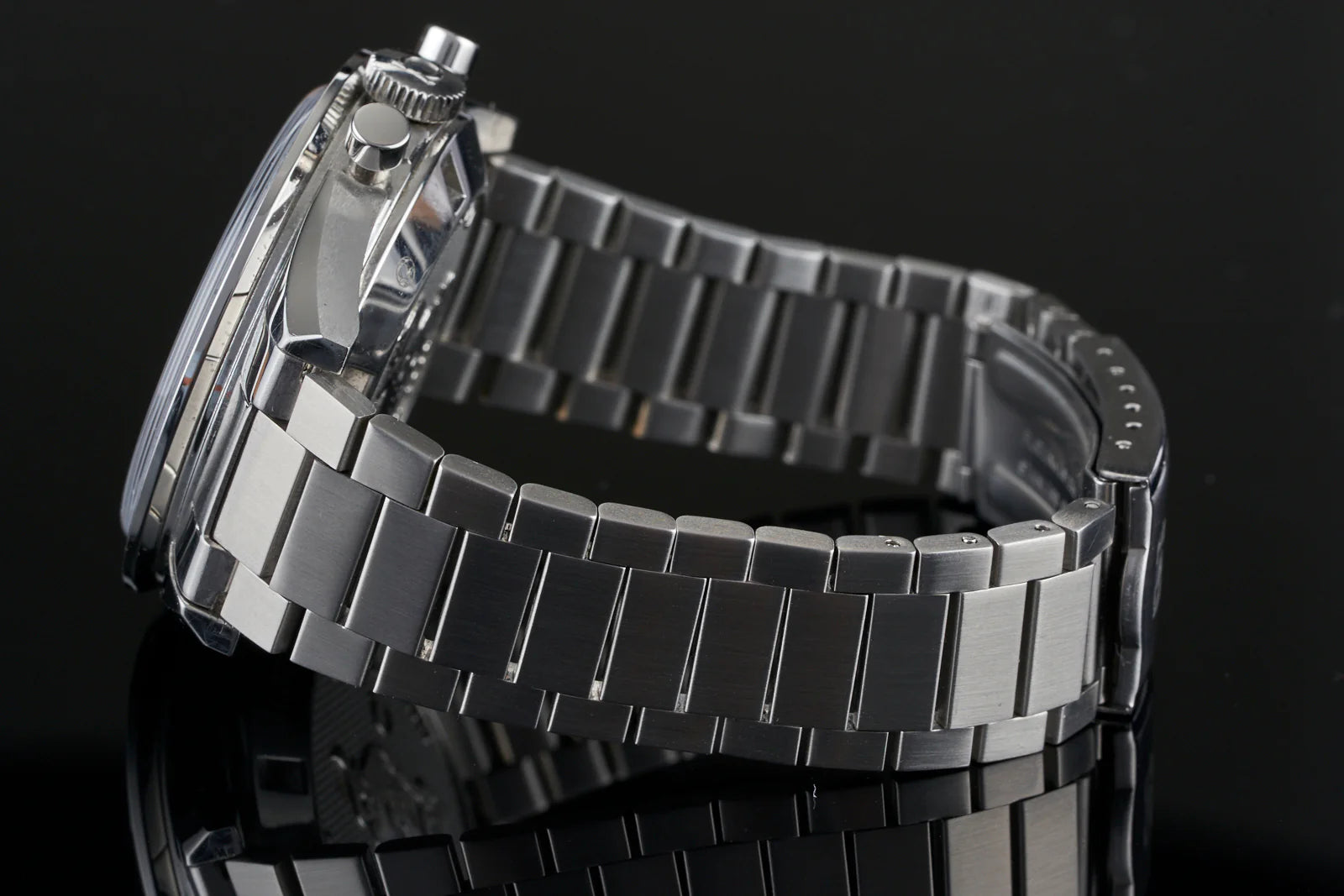Stainless steel flat link bracelet for Omega Speedmaster FOIS watch with polished and brushed finish links on black background