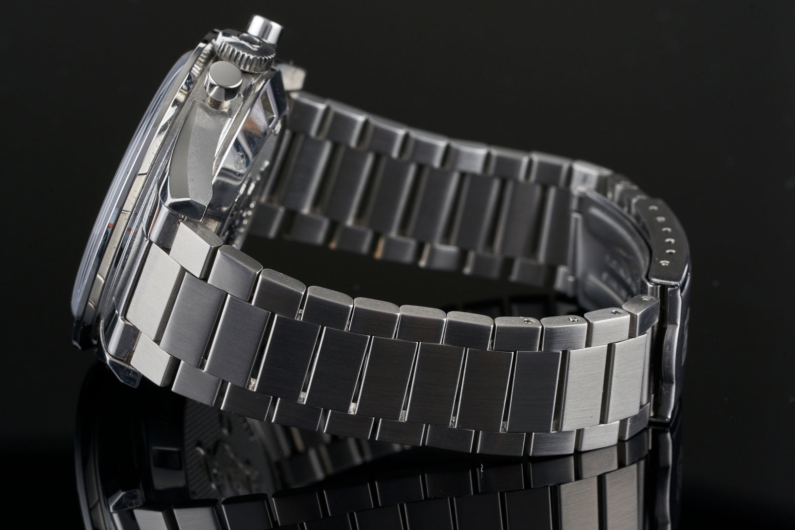 Stainless steel flat link watch bracelet for Omega Speedmaster 19/20mm lug width, displayed on black background