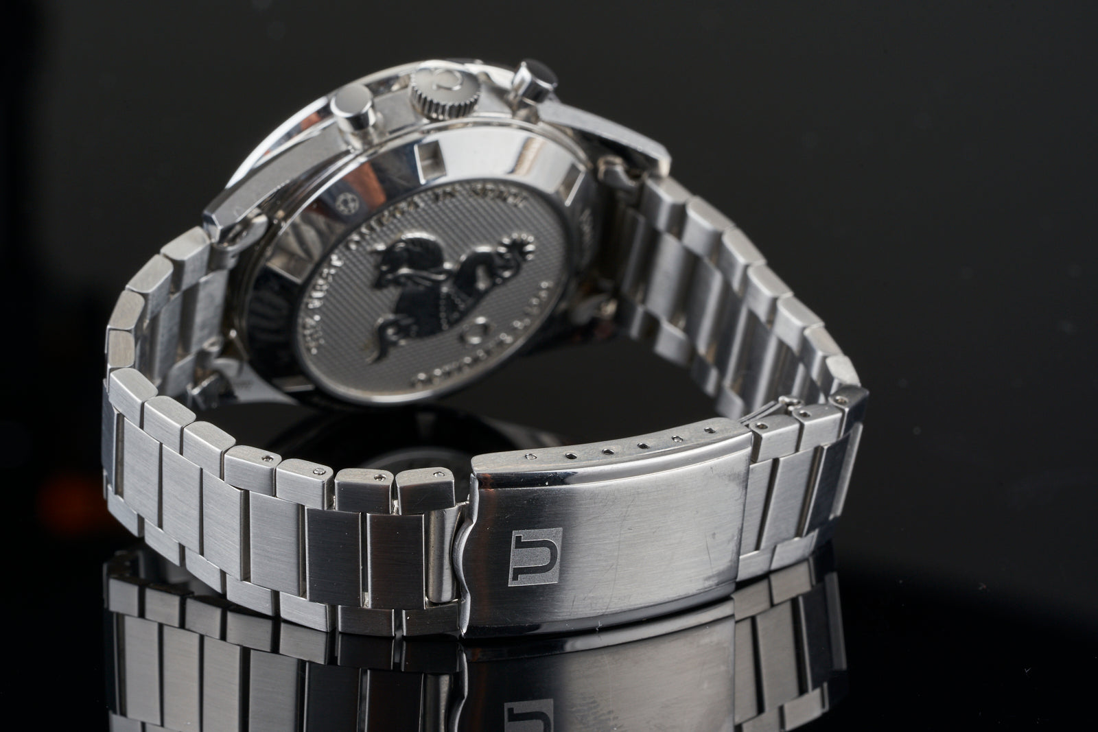 Stainless steel flat link bracelet for Omega Speedmaster watch with 19/20mm lugs, side view showing clasp and links
