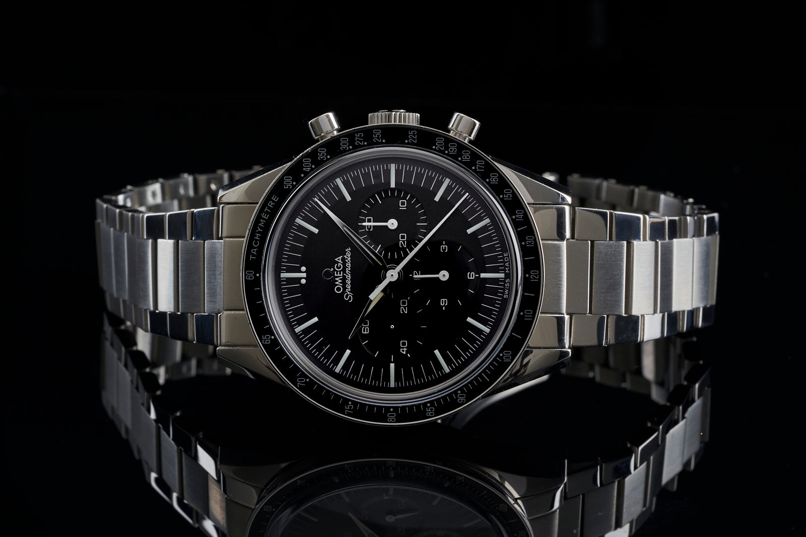 Omega Speedmaster chronograph watch with black dial, stainless steel case, and flat link bracelet on black background