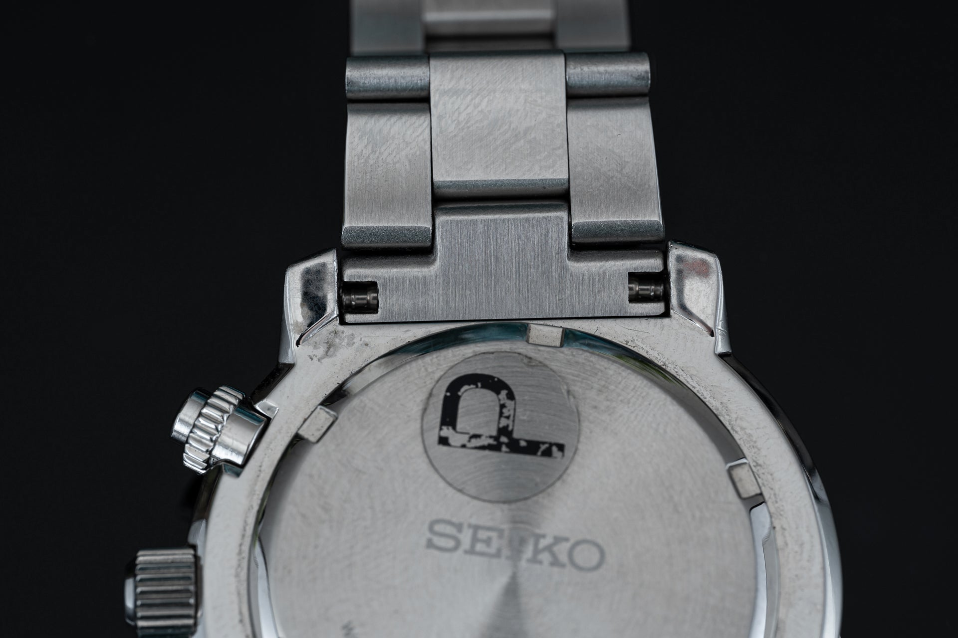 Seiko SNA411 Flightmaster stainless steel bracelet and case back detail showing military watch design
