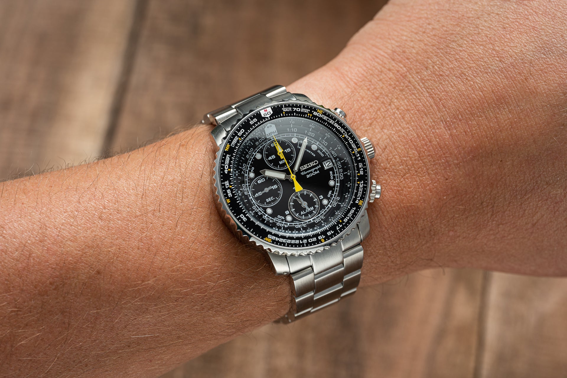 Seiko SNA411 Flightmaster chronograph watch with black dial, yellow hands, and stainless steel bracelet worn on wrist