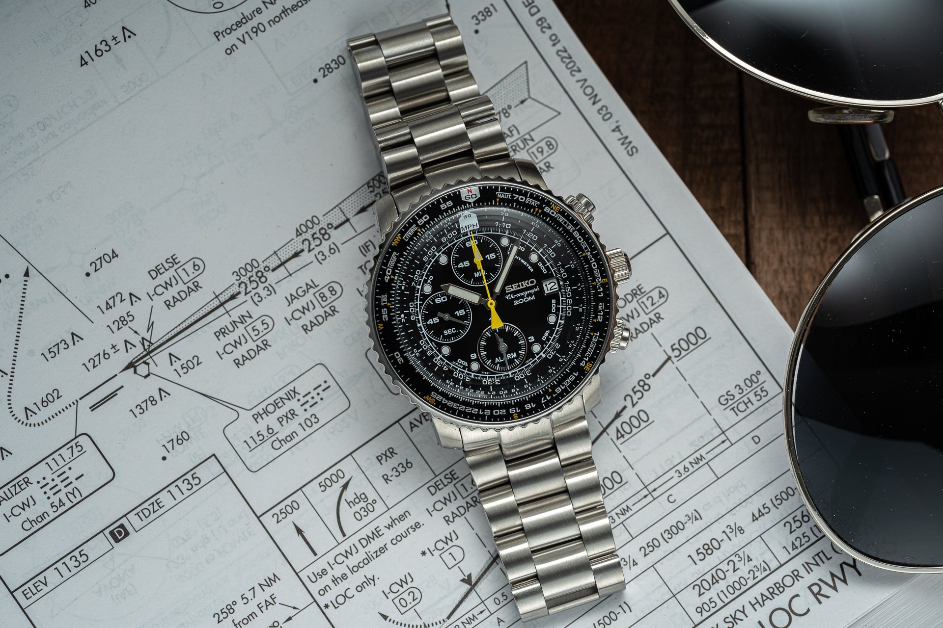 Seiko SNA411 Flightmaster chronograph watch with stainless steel bracelet and black dial on aviation chart background