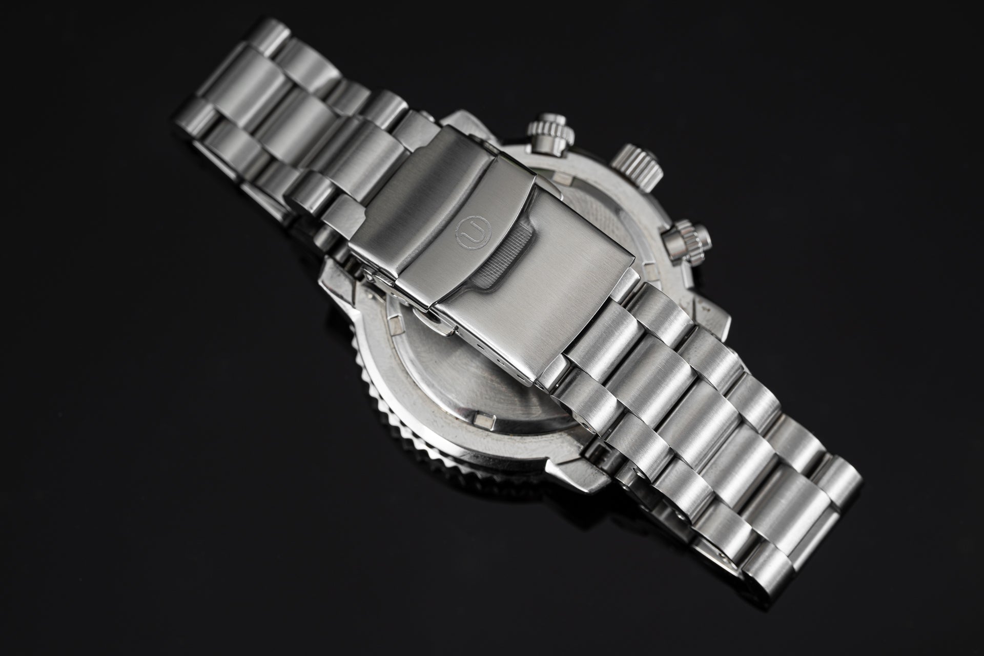 Seiko SNA411 Flightmaster stainless steel chronograph watch with metal bracelet on black background