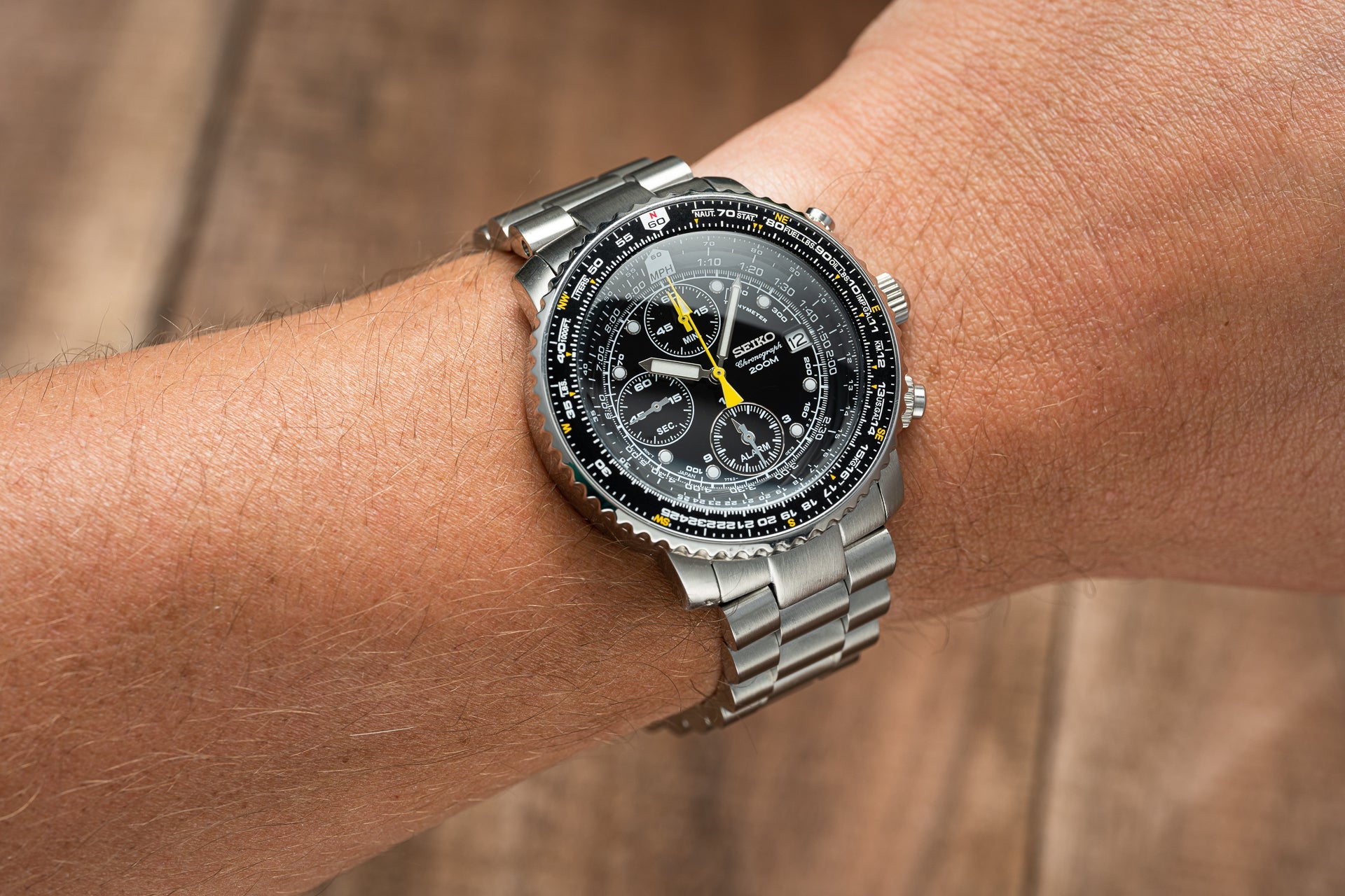Seiko SNA411 Flightmaster chronograph watch with black dial, yellow hands, and stainless steel bracelet worn on wrist