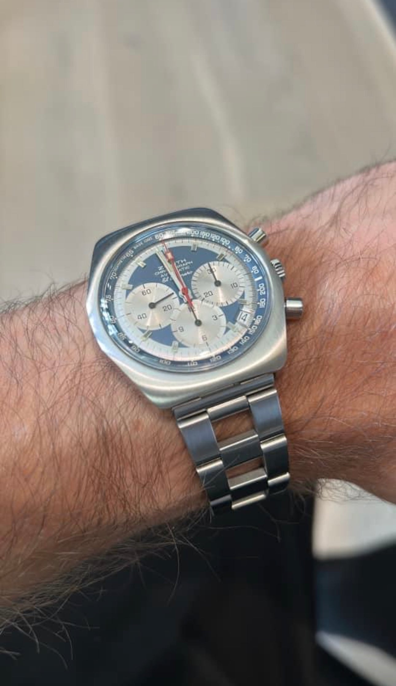 Vintage square chronograph watch with blue dial, silver stainless steel case and bracelet, worn on wrist