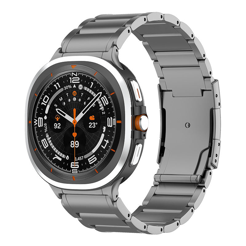 Titanium Luxe Bracelet smartwatch with square face, black dial, orange accents, and metal link band displaying fitness metrics