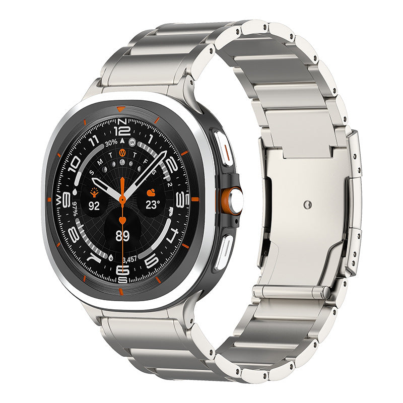 Galaxy Watch Ultra titanium smartwatch with luxe bracelet band featuring black dial and orange accents