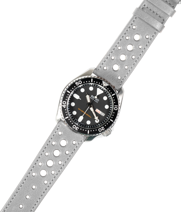 Diver watch with black dial and white hour markers on grey perforated leather quick release strap