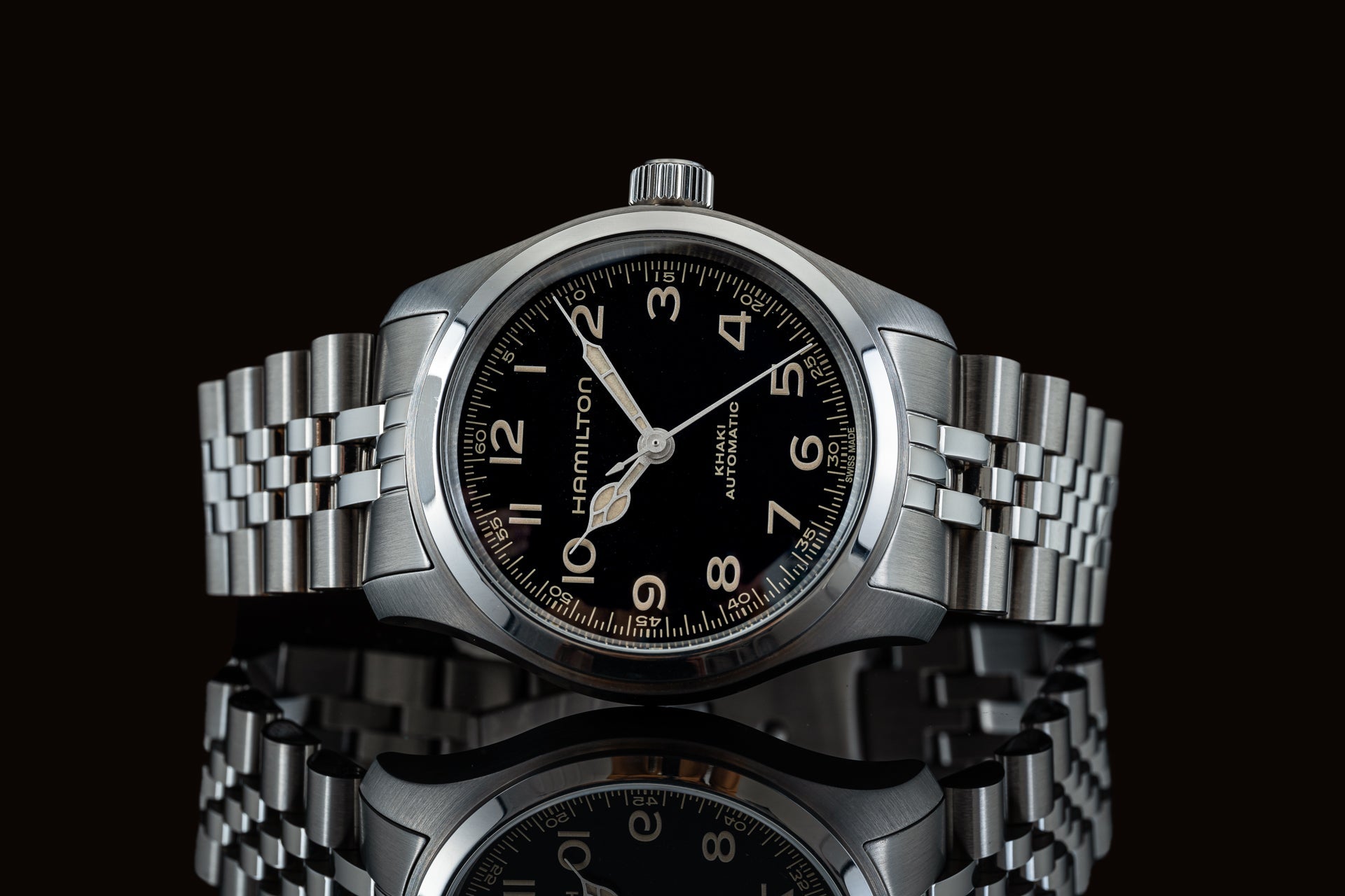 Hamilton Khaki Automatic stainless steel watch with black dial, Arabic numerals, and linked metal bracelet on black background