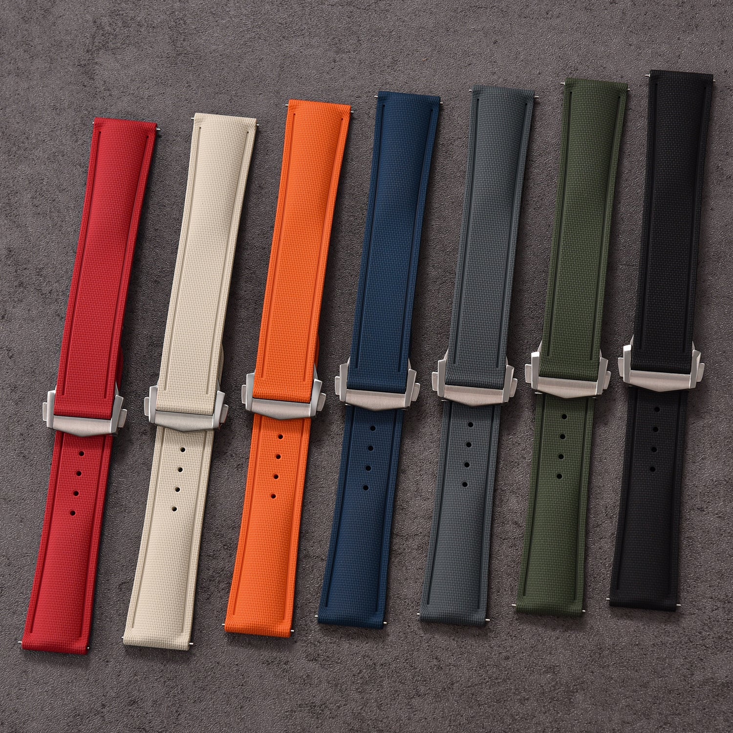 Quick release textured FKM rubber watch straps in red, cream, orange, navy, gray, olive, and black colors with white buckles