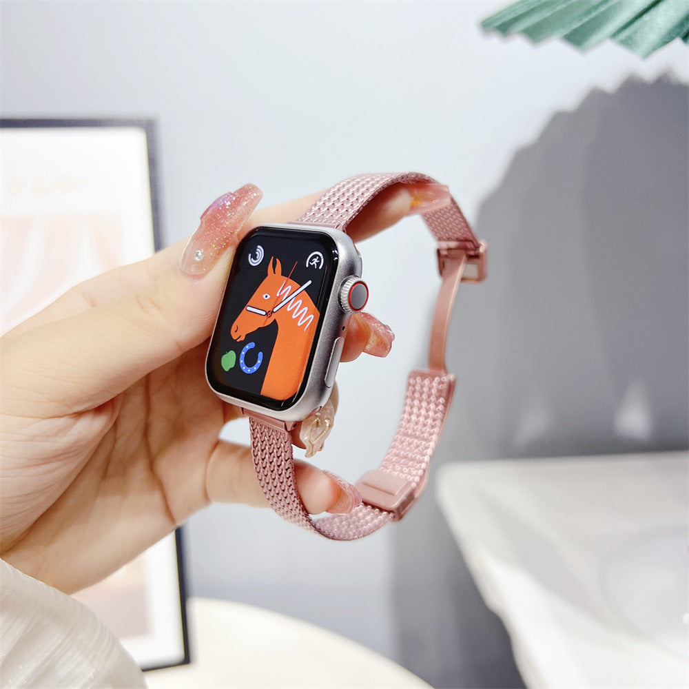 Pink herringbone mesh band smartwatch with cartoon horse face display, held in hand showing woven metal bracelet design