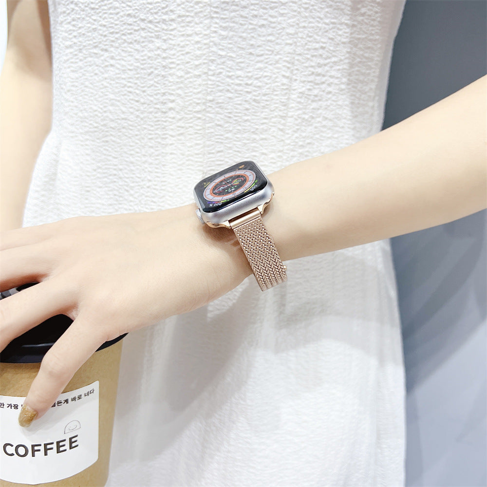 Woman wearing rose gold herringbone mesh smart watch band with square digital watch face on wrist