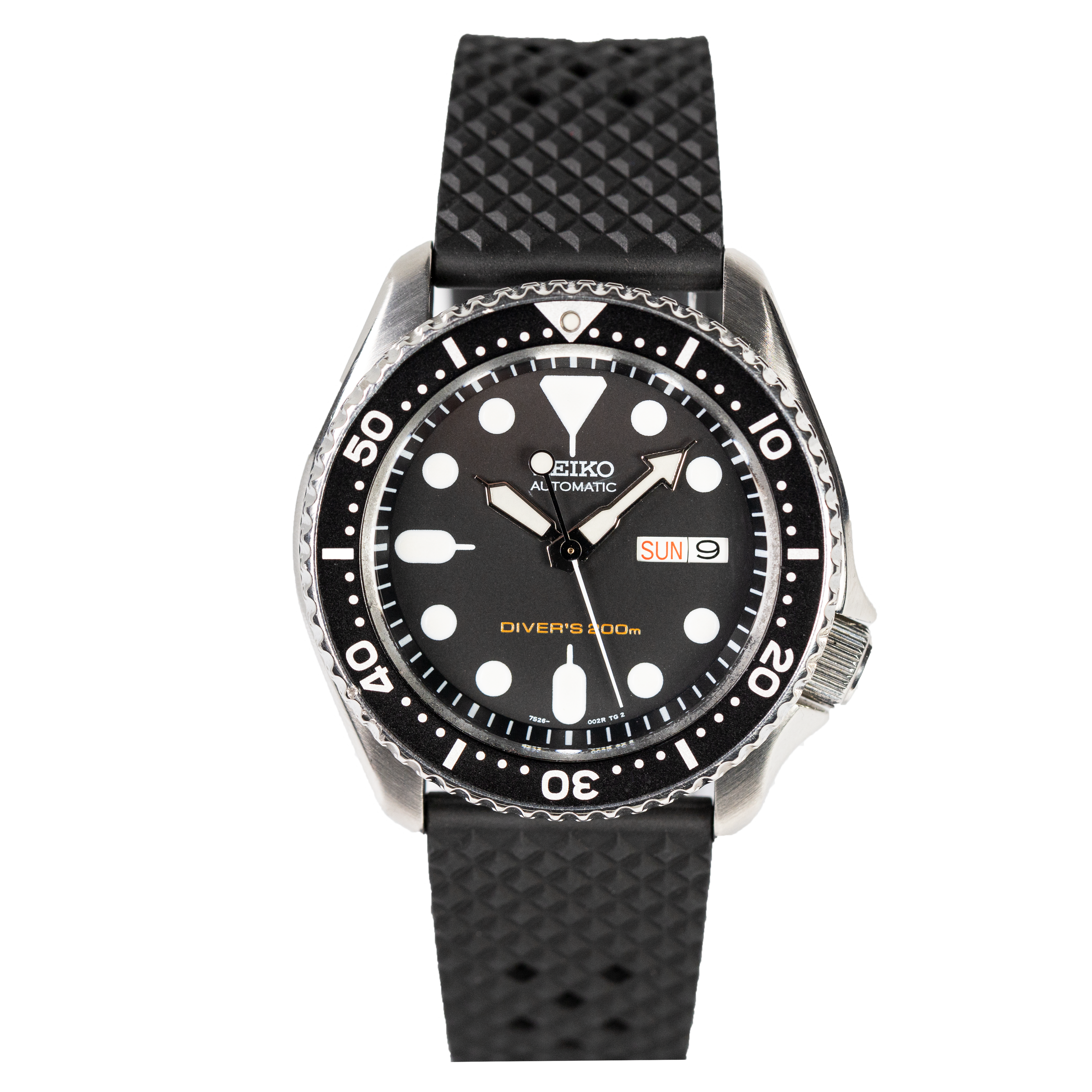 Seiko automatic dive watch with black dial, luminous hour markers, day-date window, 300m water resistance and rubber strap