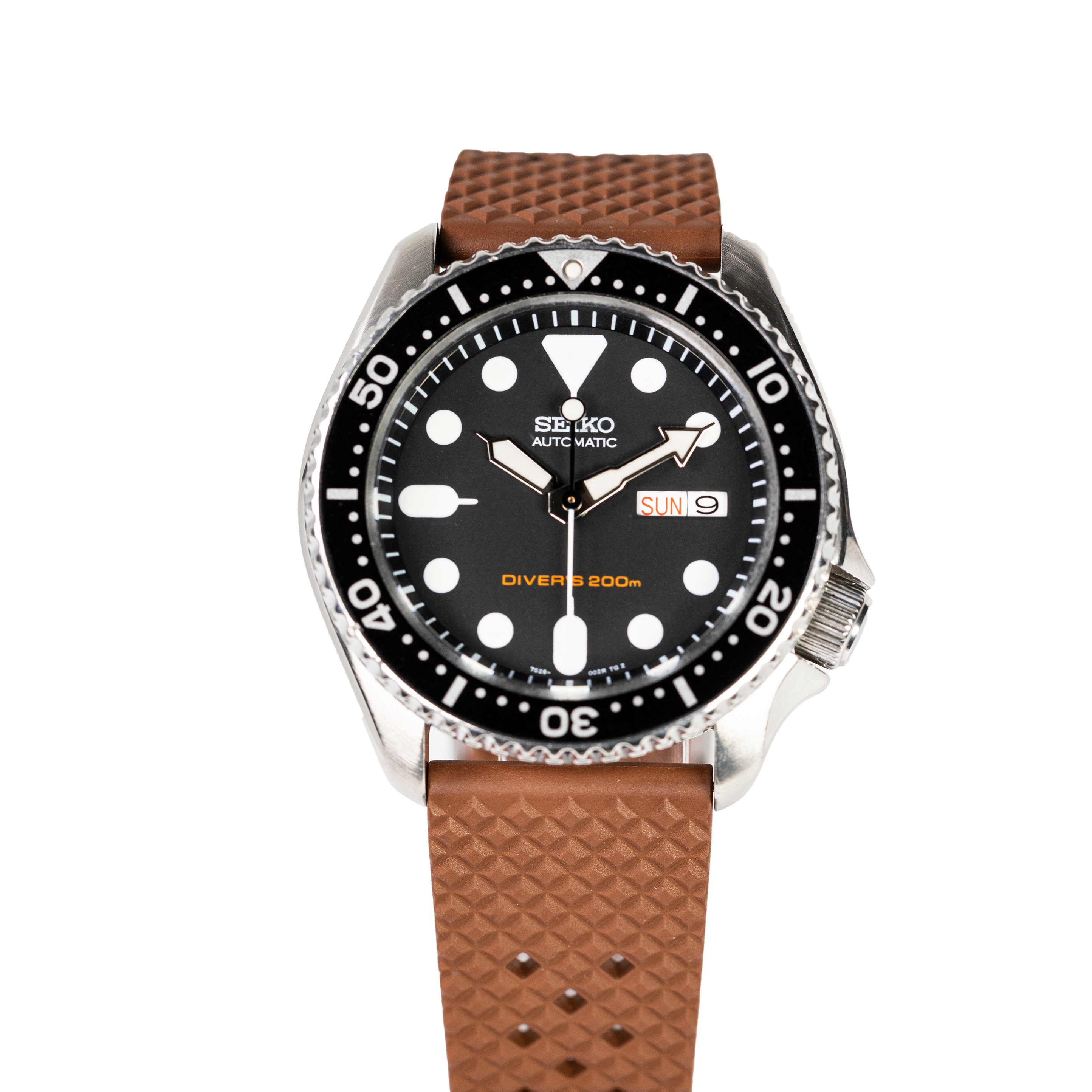 Seiko automatic dive watch with black dial, stainless steel case, and brown textured FKM rubber strap with quick release