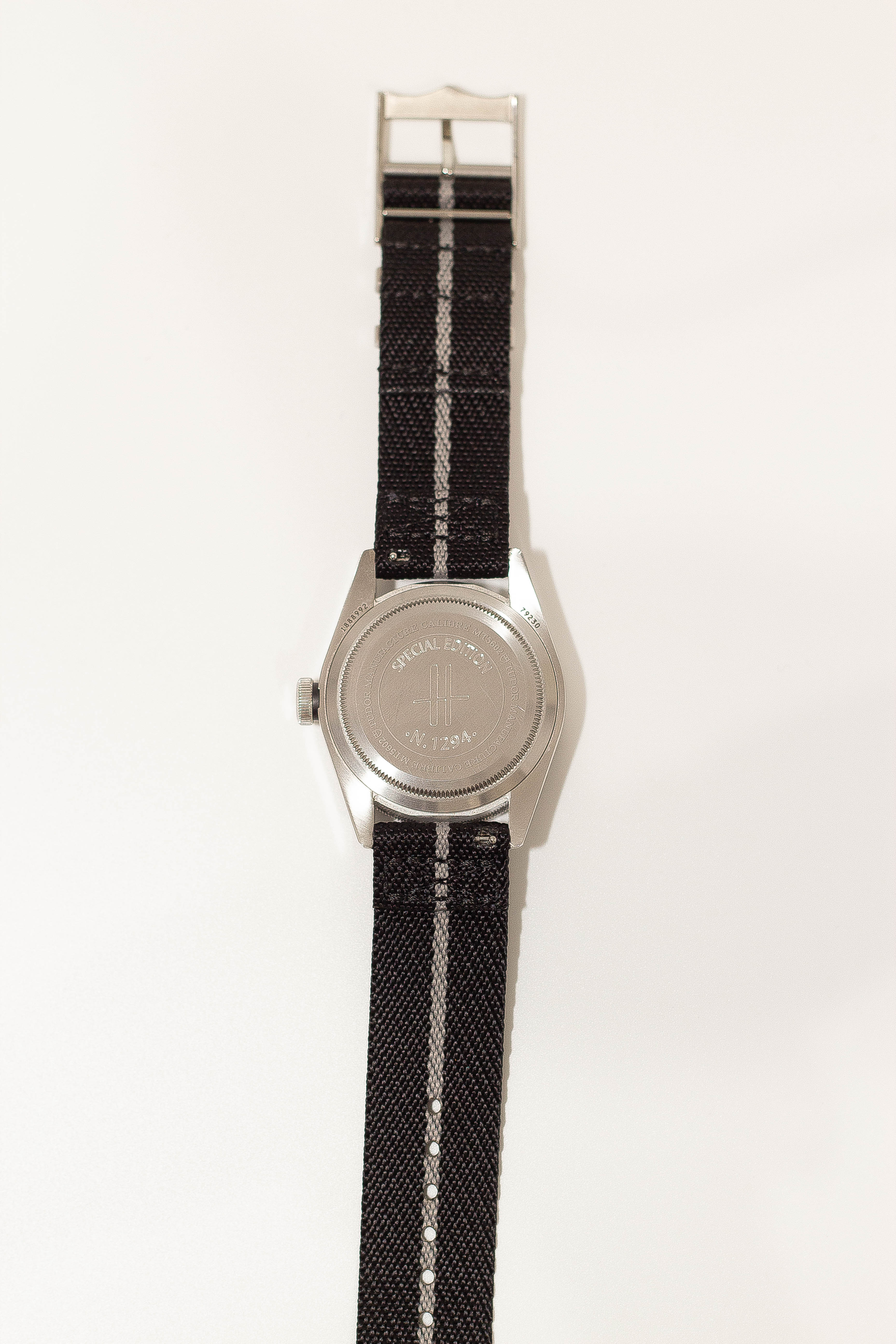 Silver-tone watch with black and white striped fabric strap and special edition military dial design