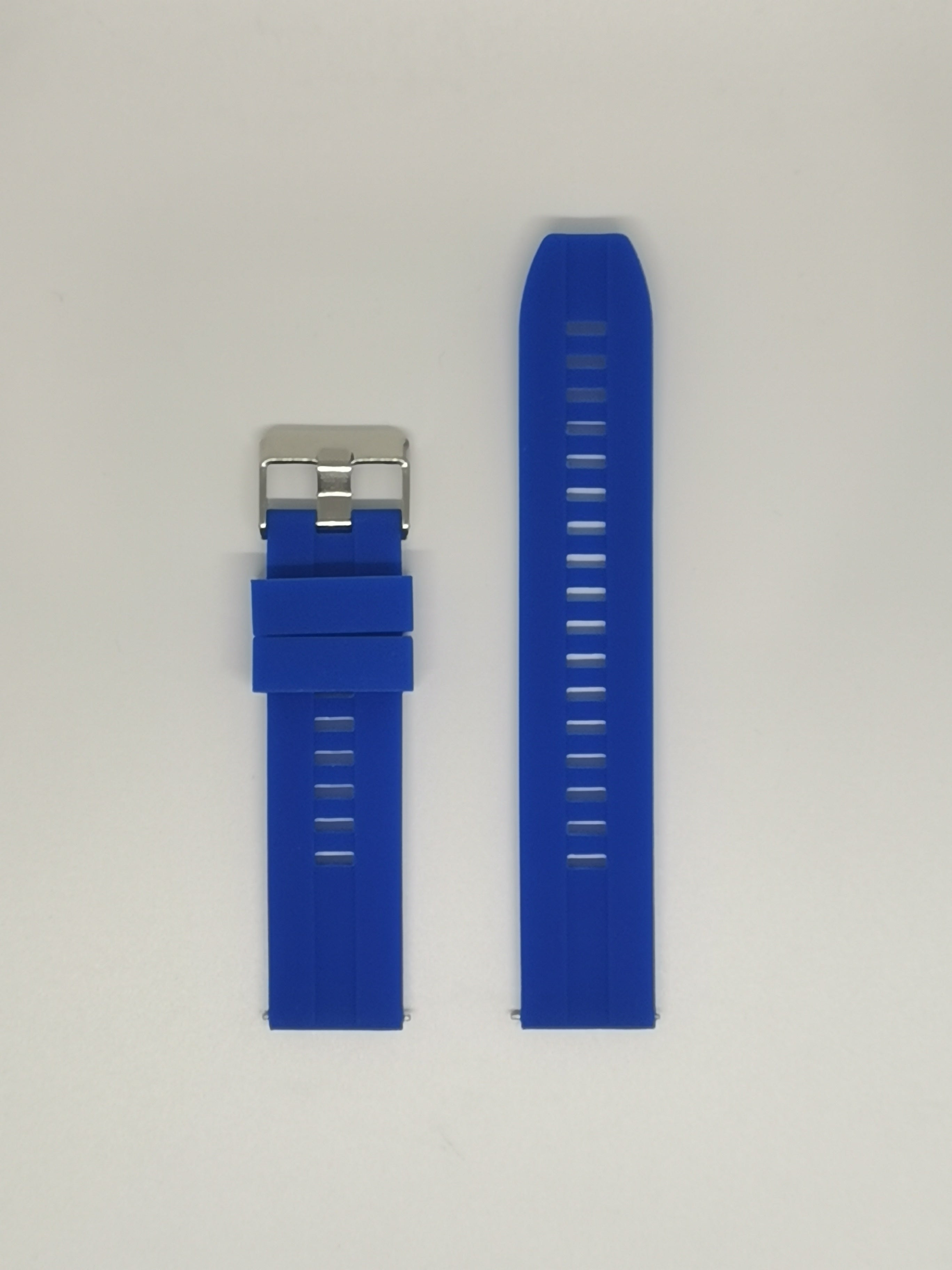 Blue silicone watch band with silver buckle clasp and ventilation holes, shown attached and detached