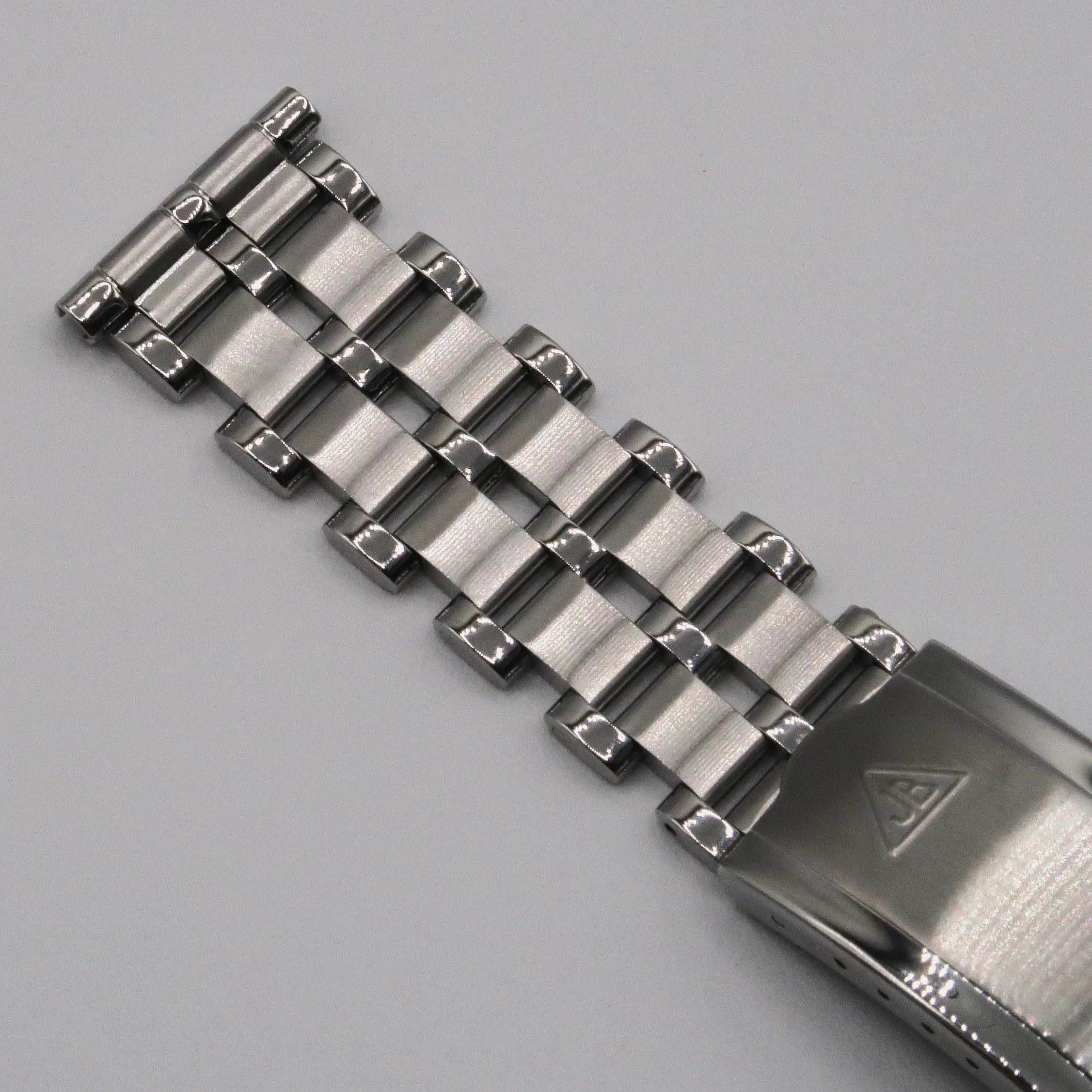 Stainless steel five-row beads of rice watch bracelet with polished end link and mesh center links on gray background