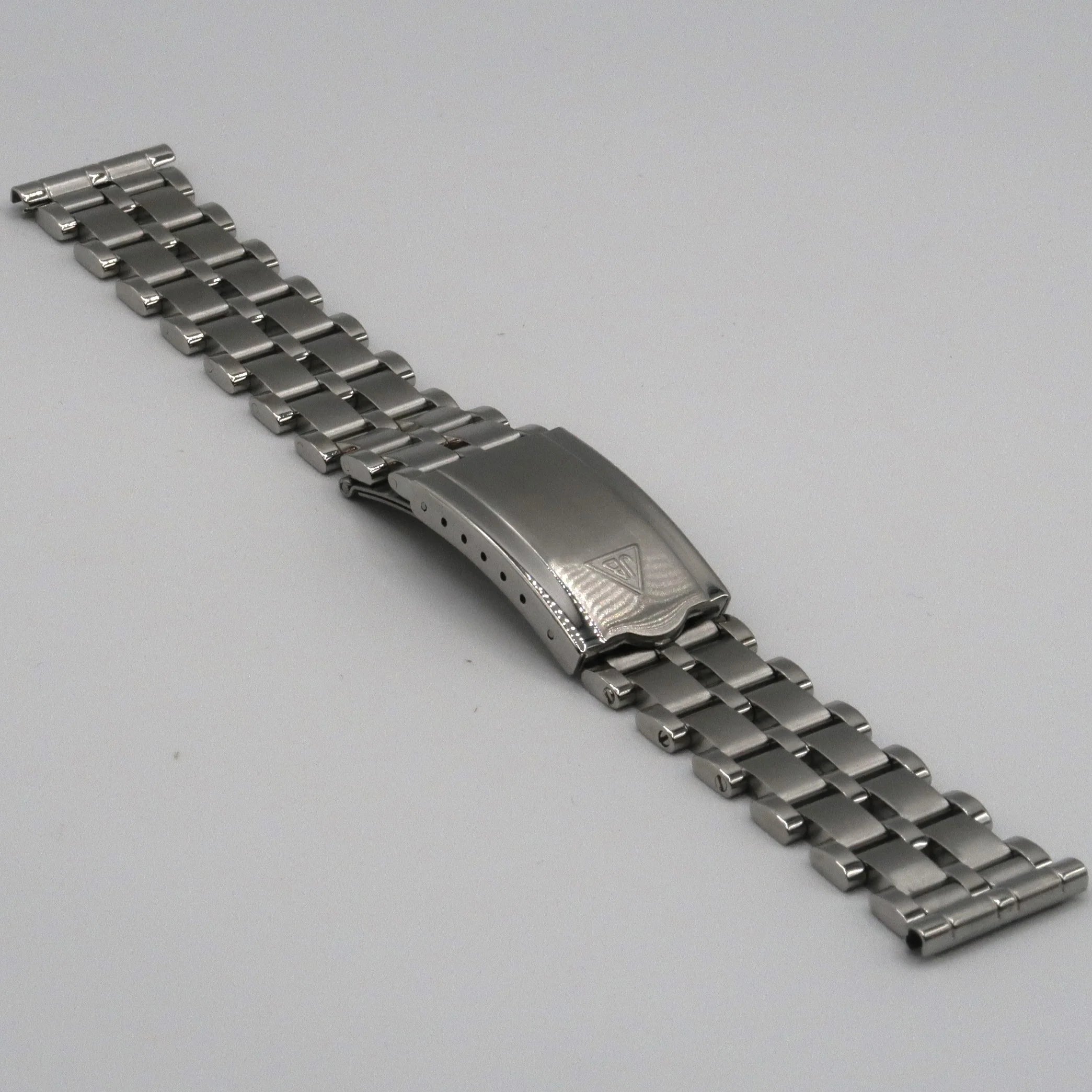 Stainless steel five-row beads of rice watch bracelet with fold-over clasp on gray background