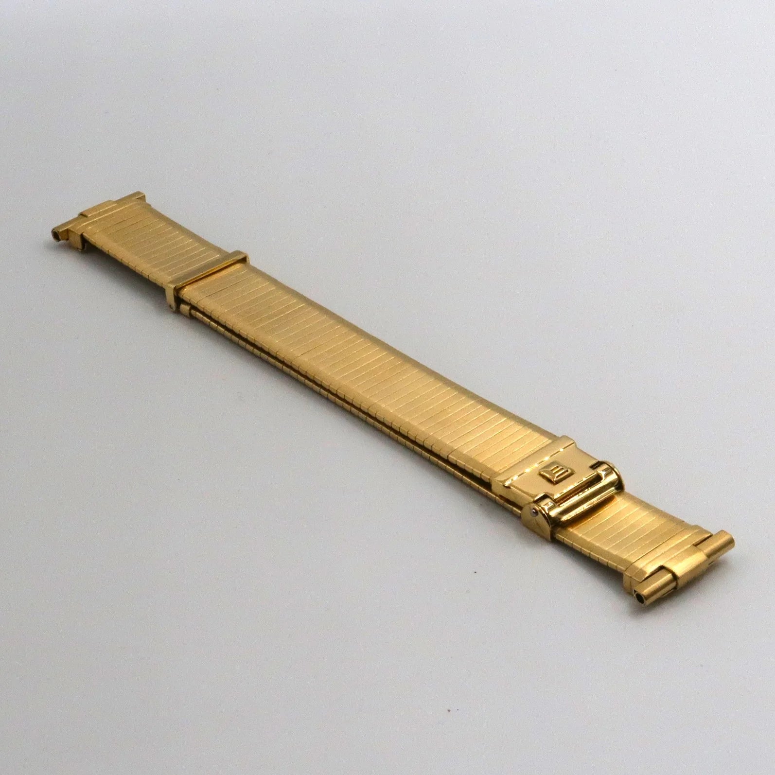 Gold plated stainless steel military watch band with brushed finish and deployment clasp