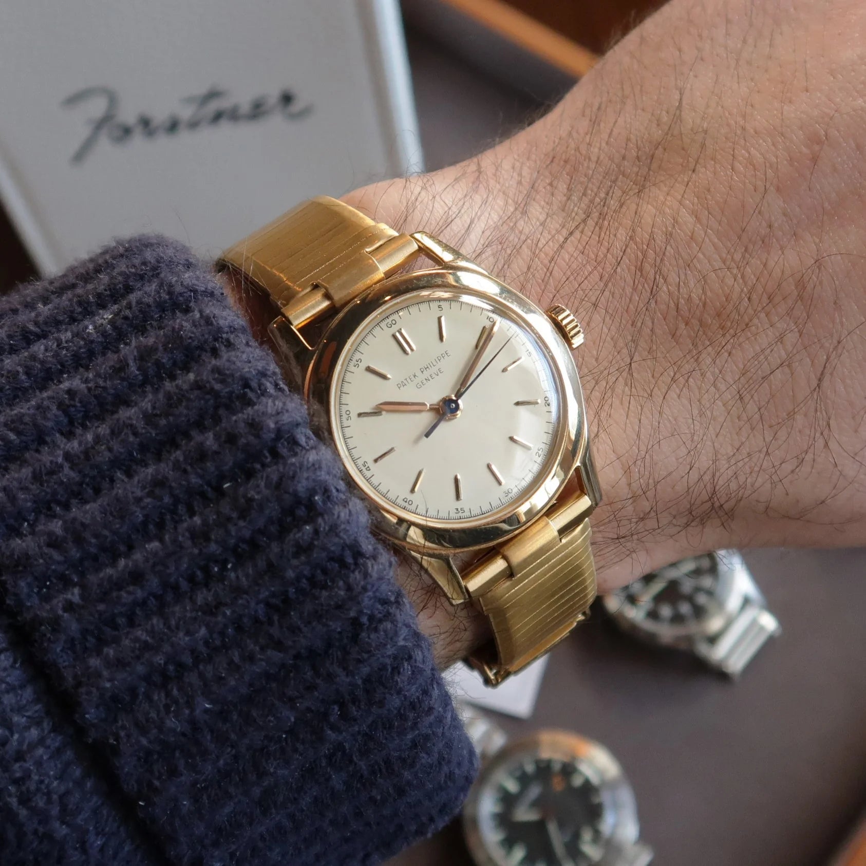 Gold plated Forstner Komfit military-style watch with cream dial and slender case on wrist