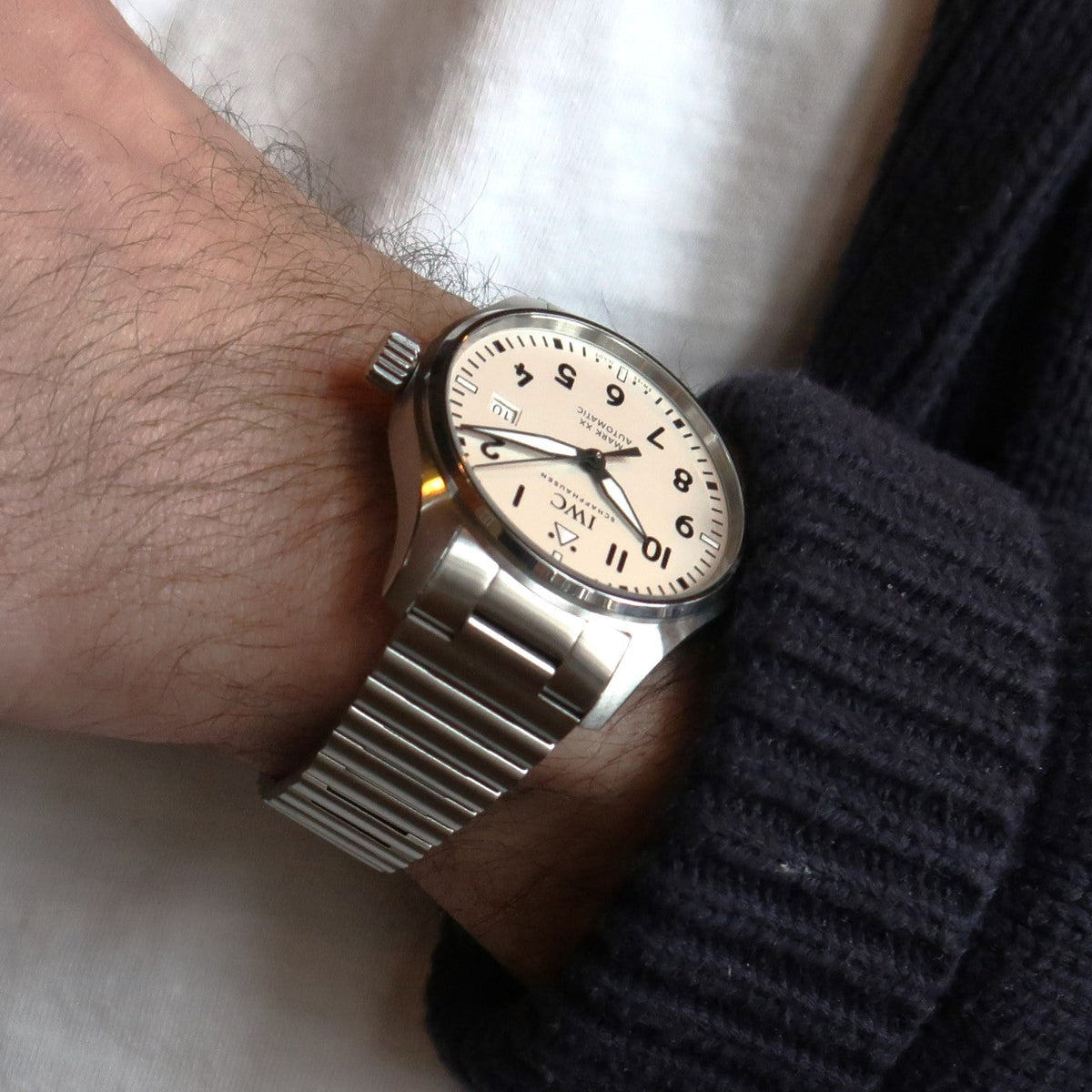 Stainless steel IWC Mark XX watch with cream dial and barrel bracelet worn on wrist