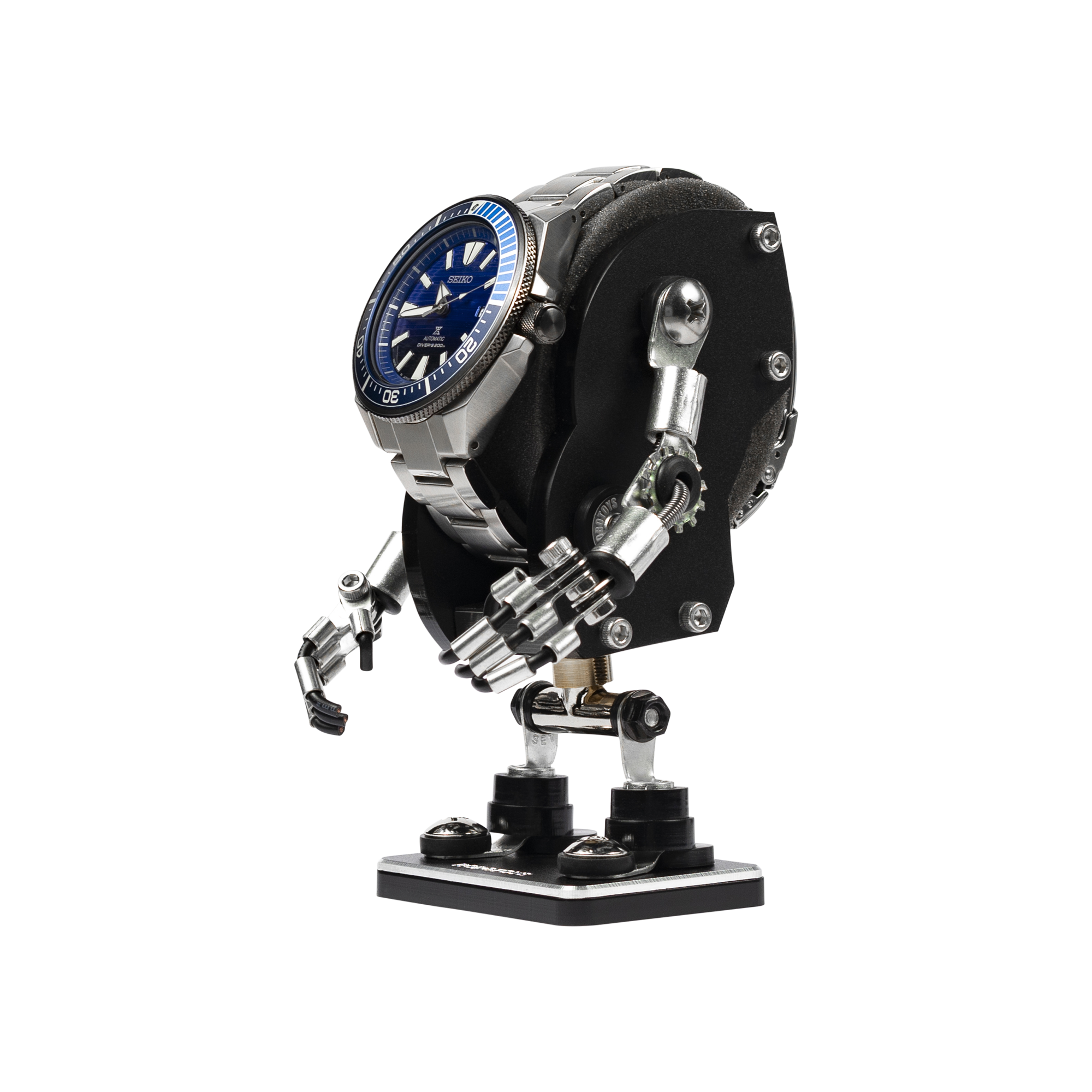 Minibot black watch stand with articulated metal arms and hands holding steel dive watch with blue dial on base