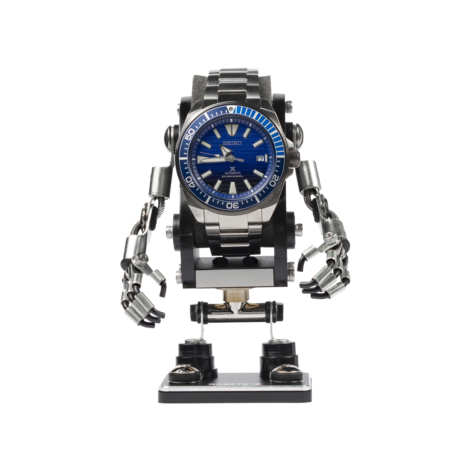 Black robotic watch stand holding Seiko automatic dive watch with articulated metal arms and legs on base