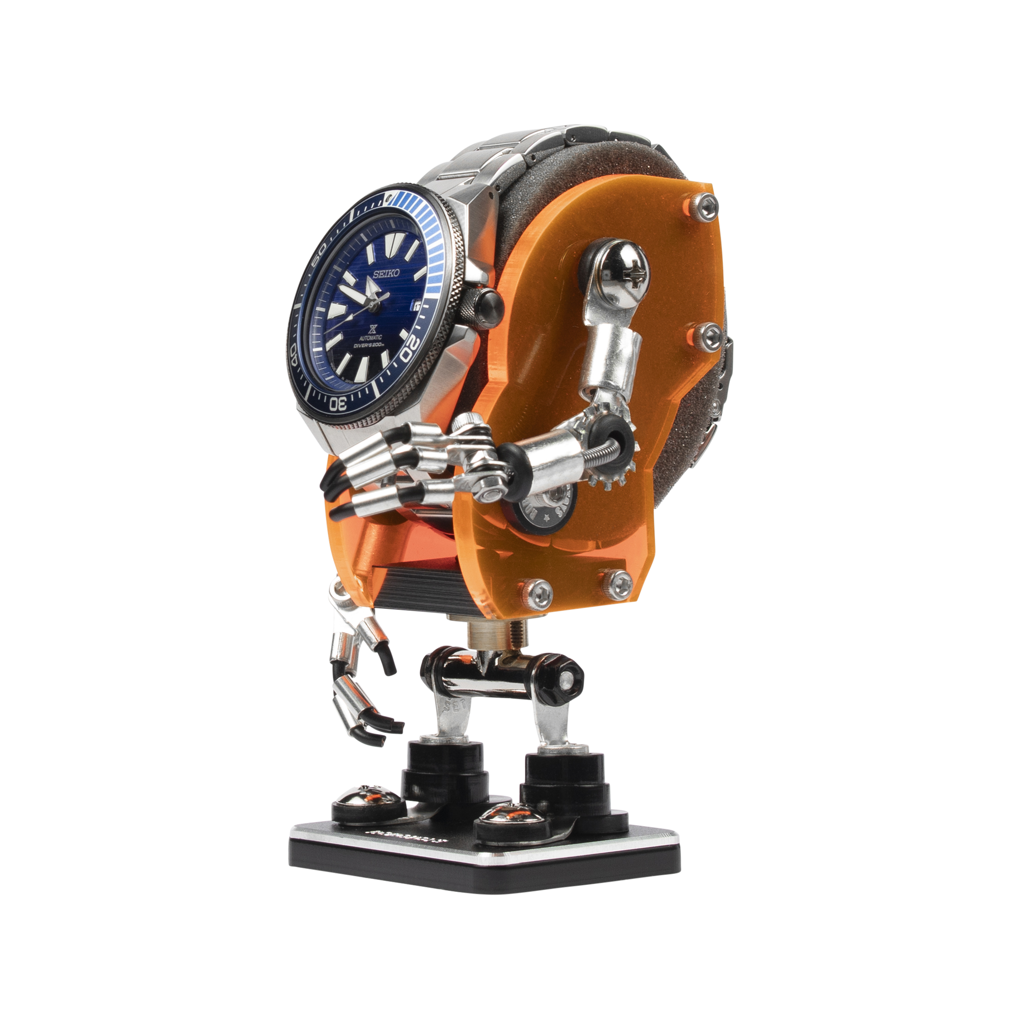 Neon orange Minibot watch stand holding Seiko dive watch with articulated metal limbs and black base