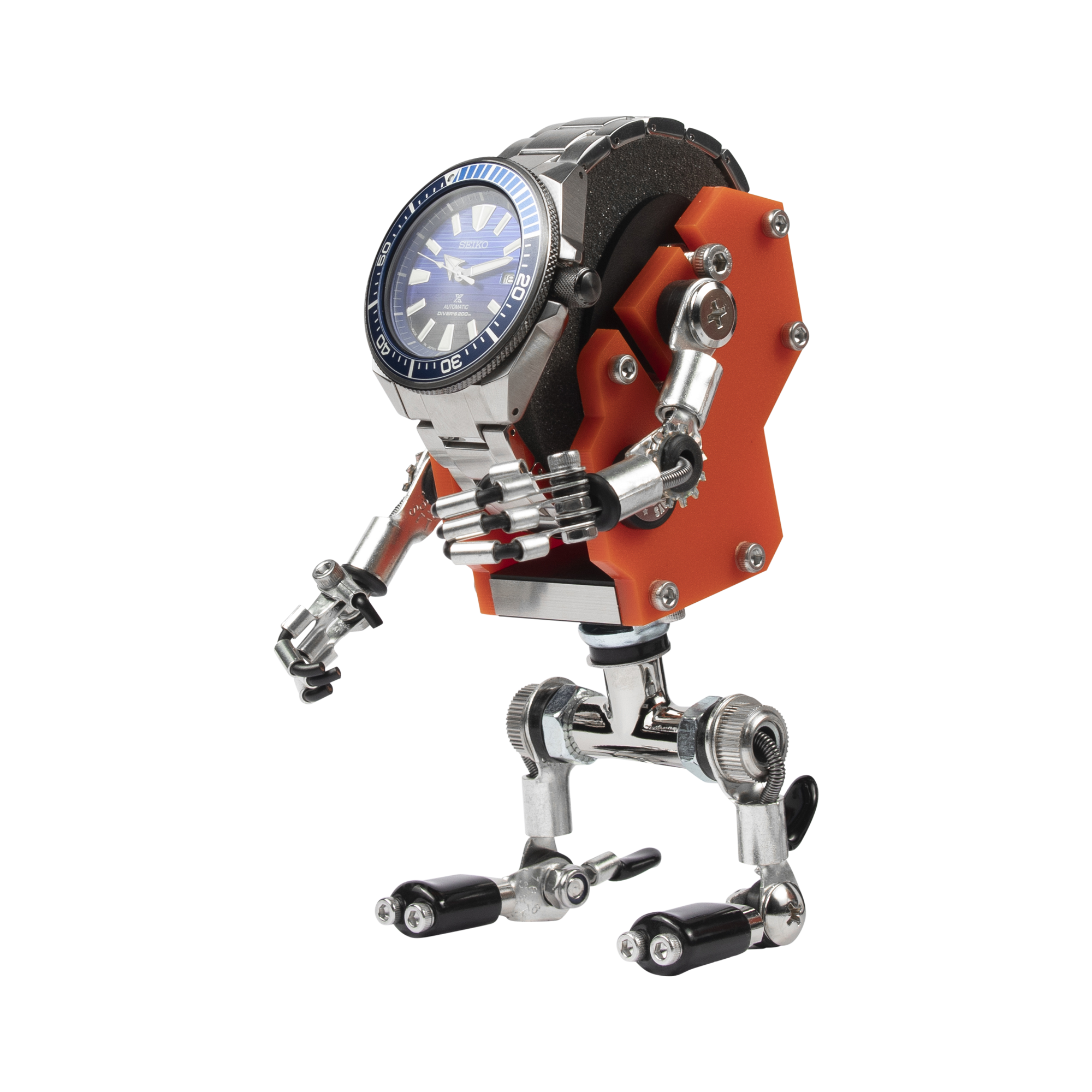 Orange MiniMech robot watch stand holding blue dial timepiece with articulated metal limbs and mechanical details